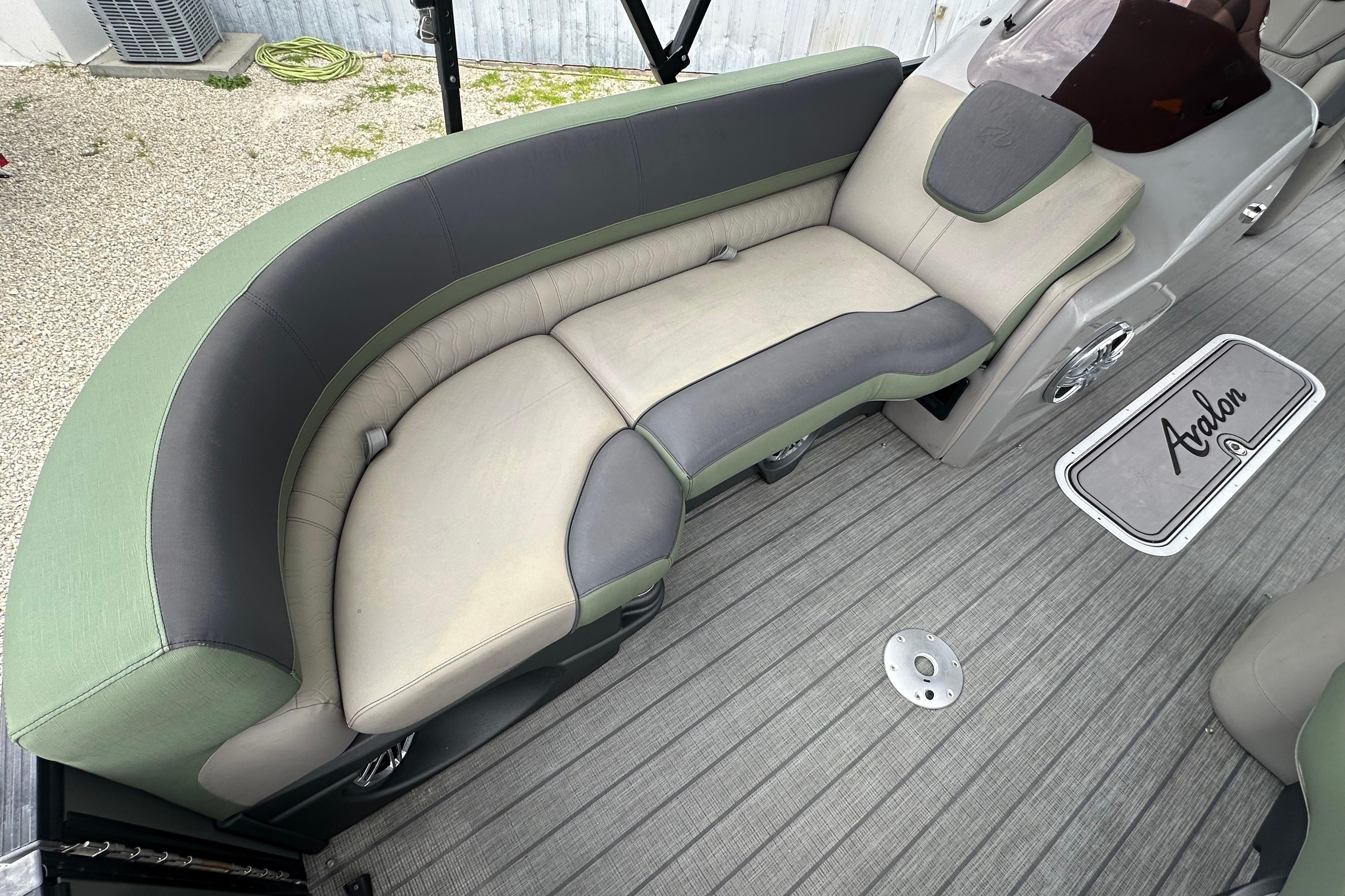 2023 Avalon Catalina Quad Lounge boat interior with stylish seating and branded flooring.