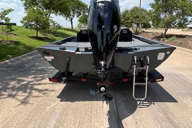 2026 Ranger RT188 boat with outboard motor, parked on a sunny road.