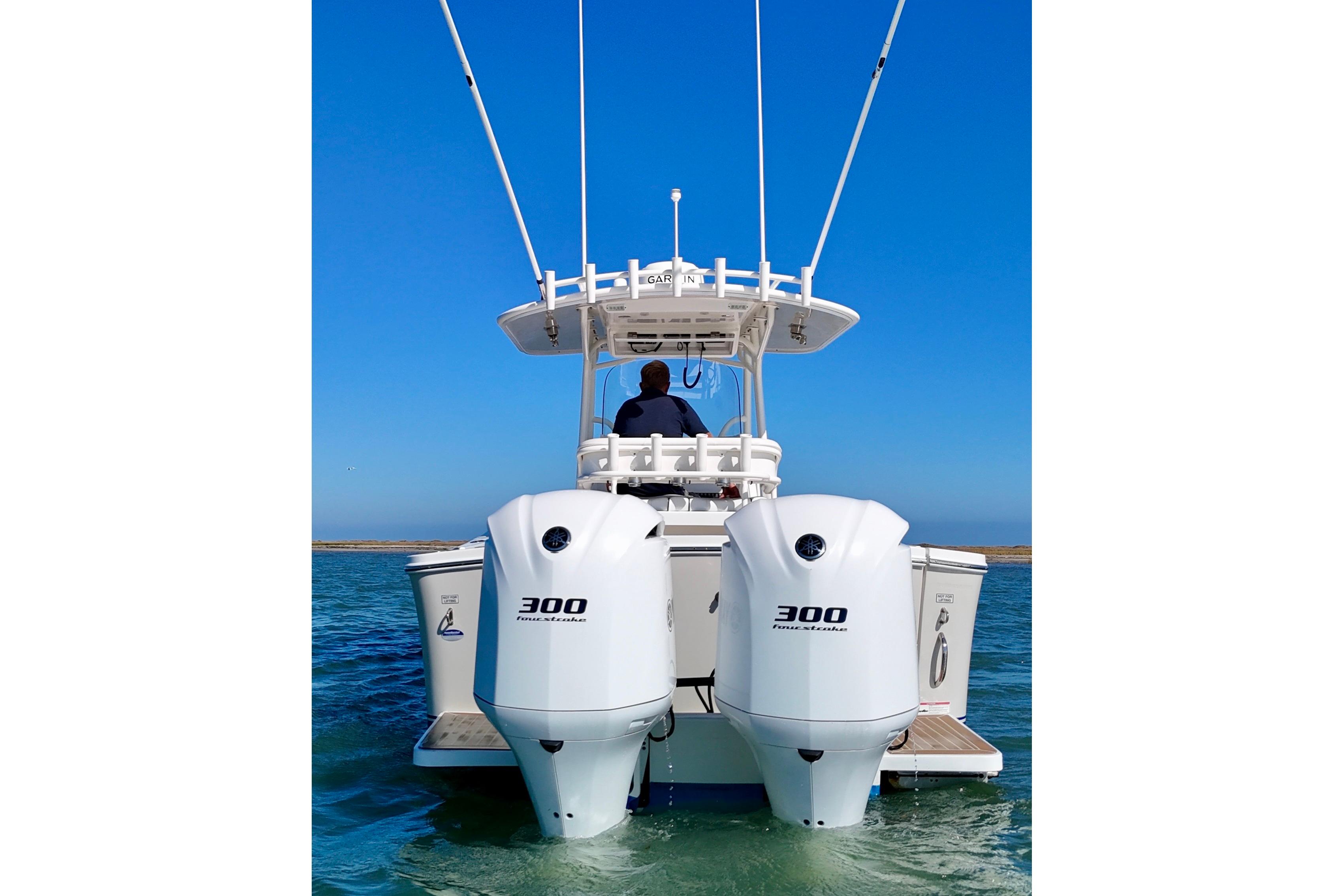 2016 Regulator 28 Forward Seating boat with twin 300 horsepower engines on water.