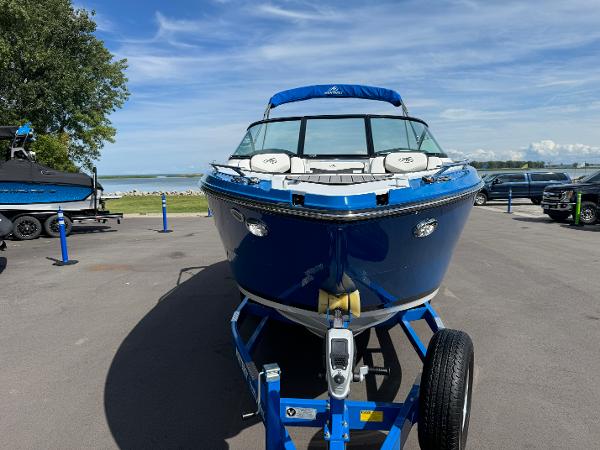 2018 Monterey 258 Super Sport boat on trailer, parked near a scenic waterfront.