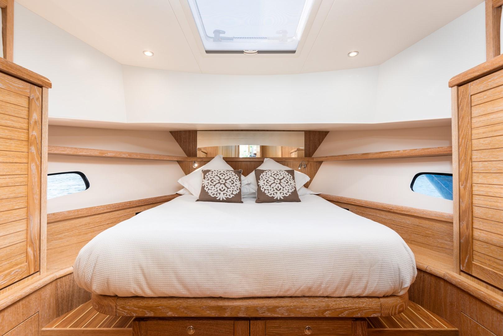 Luxurious cabin interior of 2025 Sasga Yachts Menorquin 42 with skylight and wooden accents.