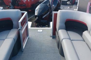 2026 Sun Tracker Party Barge 22 XP3 interior with seating and Mercury outboard motor.
