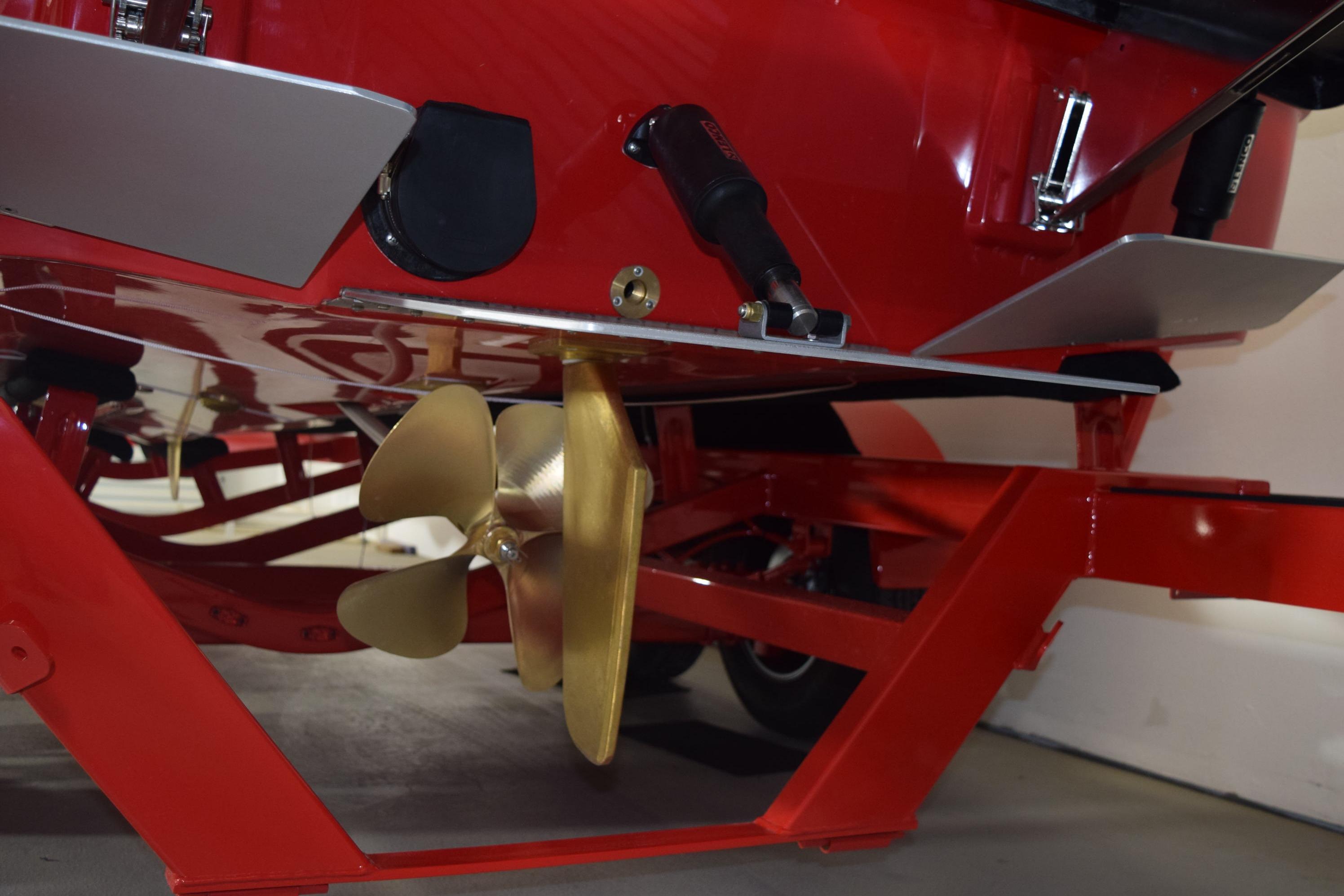 2026 Moomba Craz boat underside with propeller and red trailer.