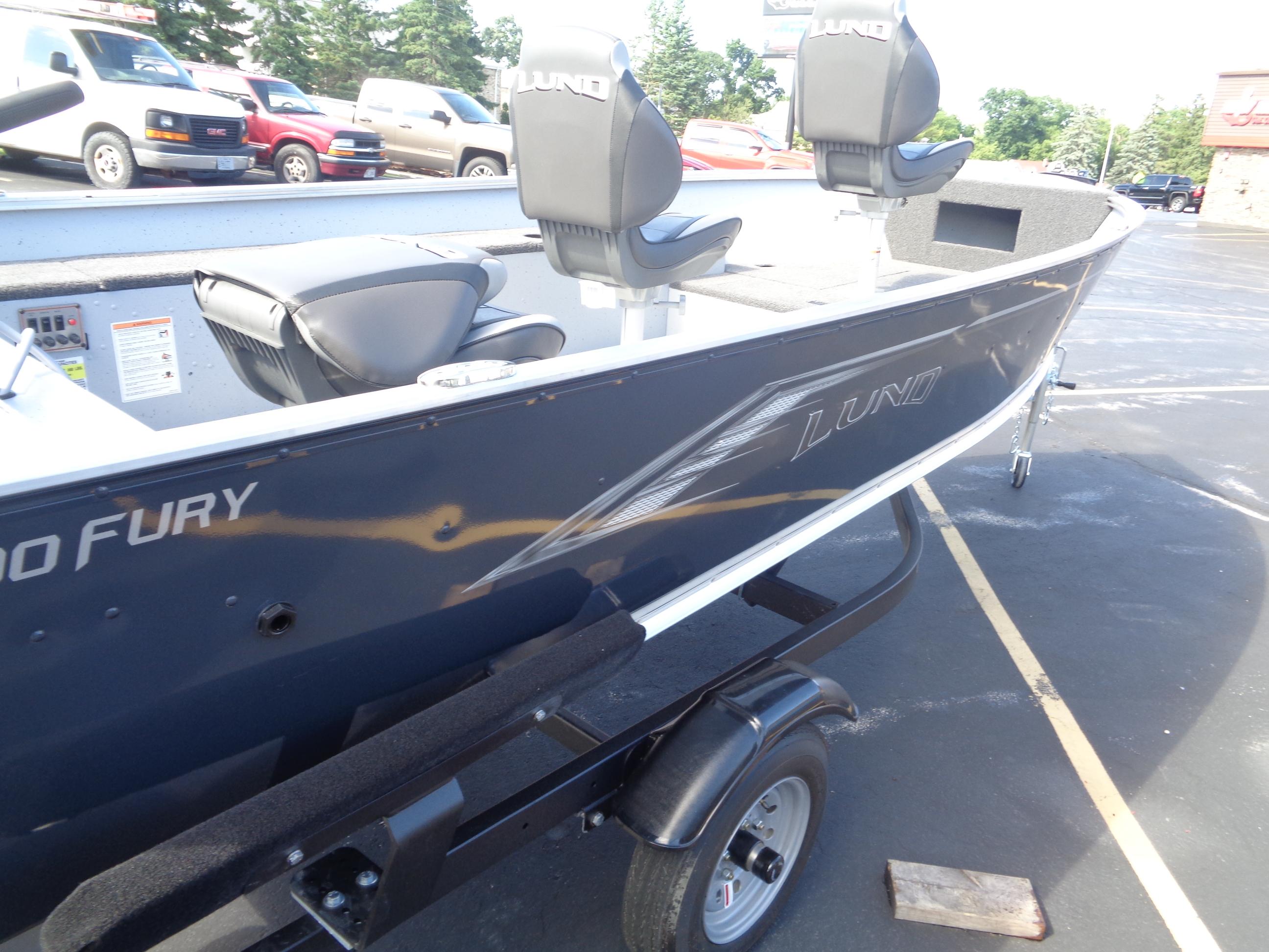 2025 Lund 1400 Fury Tiller boat on trailer, featuring sleek design and comfortable seating.