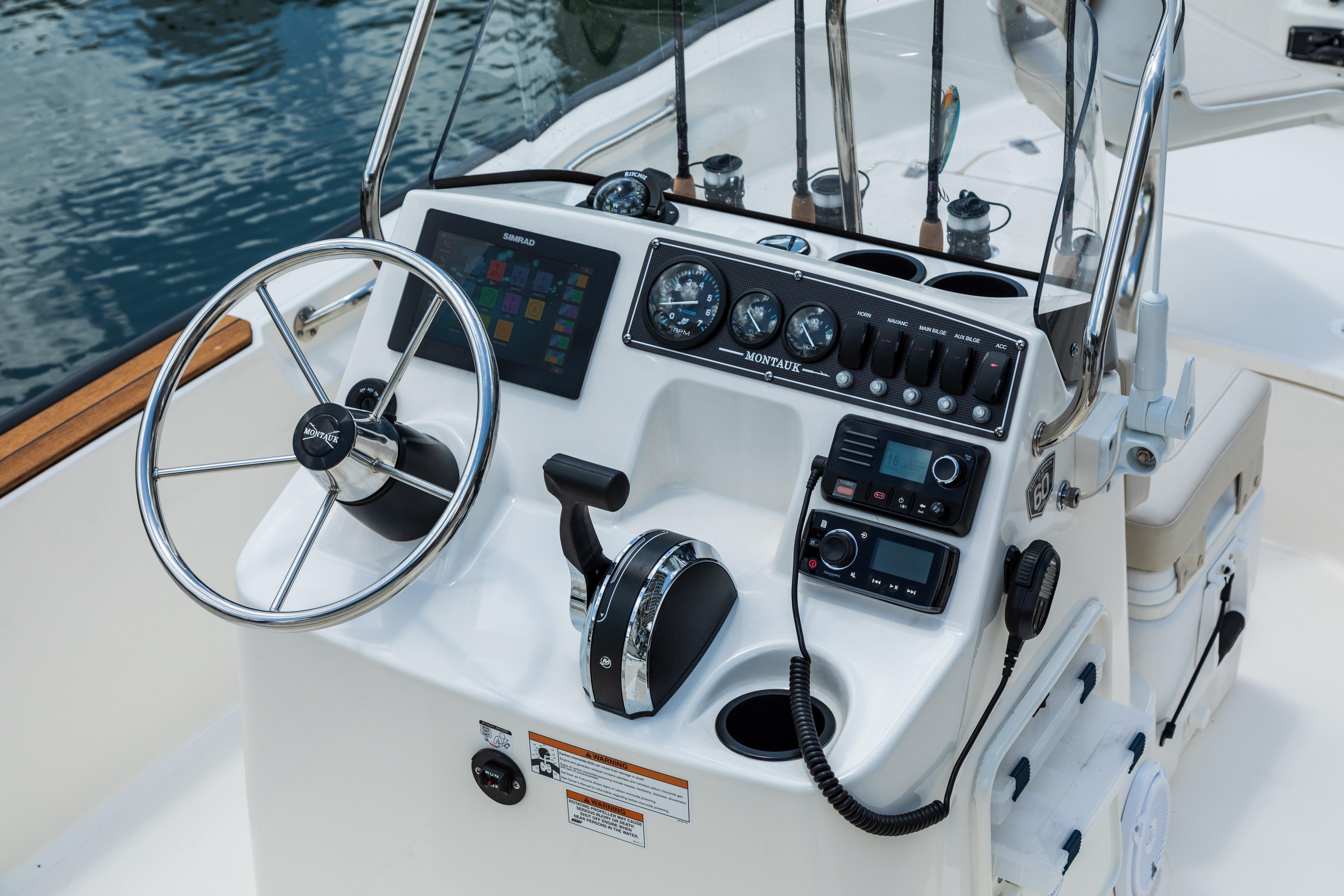 2025 Boston Whaler 170 Montauk boat console with steering wheel and controls.
