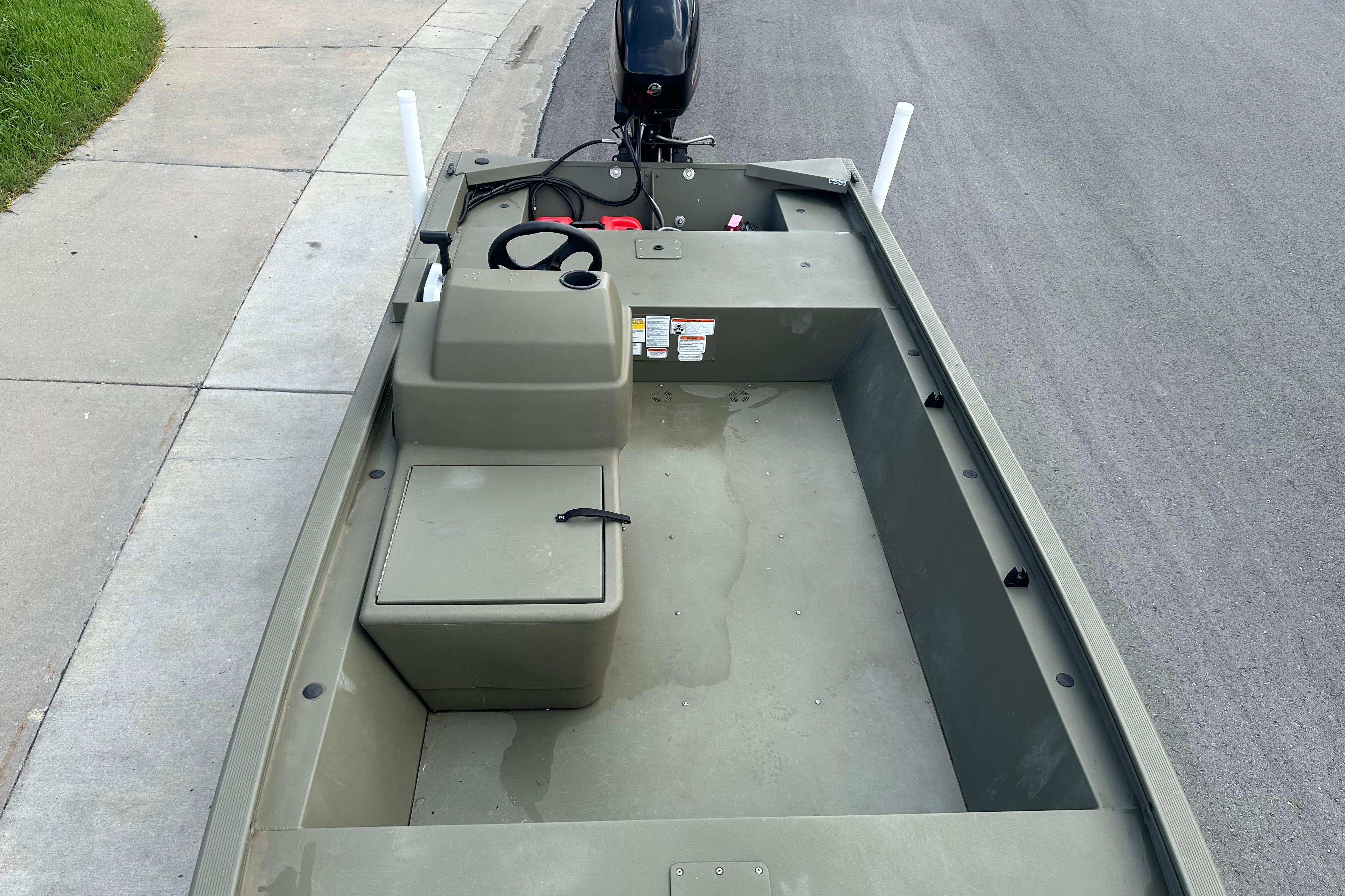 2024 Tracker Grizzly 1648 SC boat interior with steering console and seating.