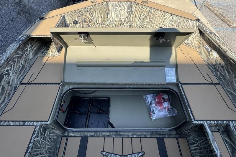 2026 Tracker Grizzly 1756 T Marsh boat interior with open storage compartment.