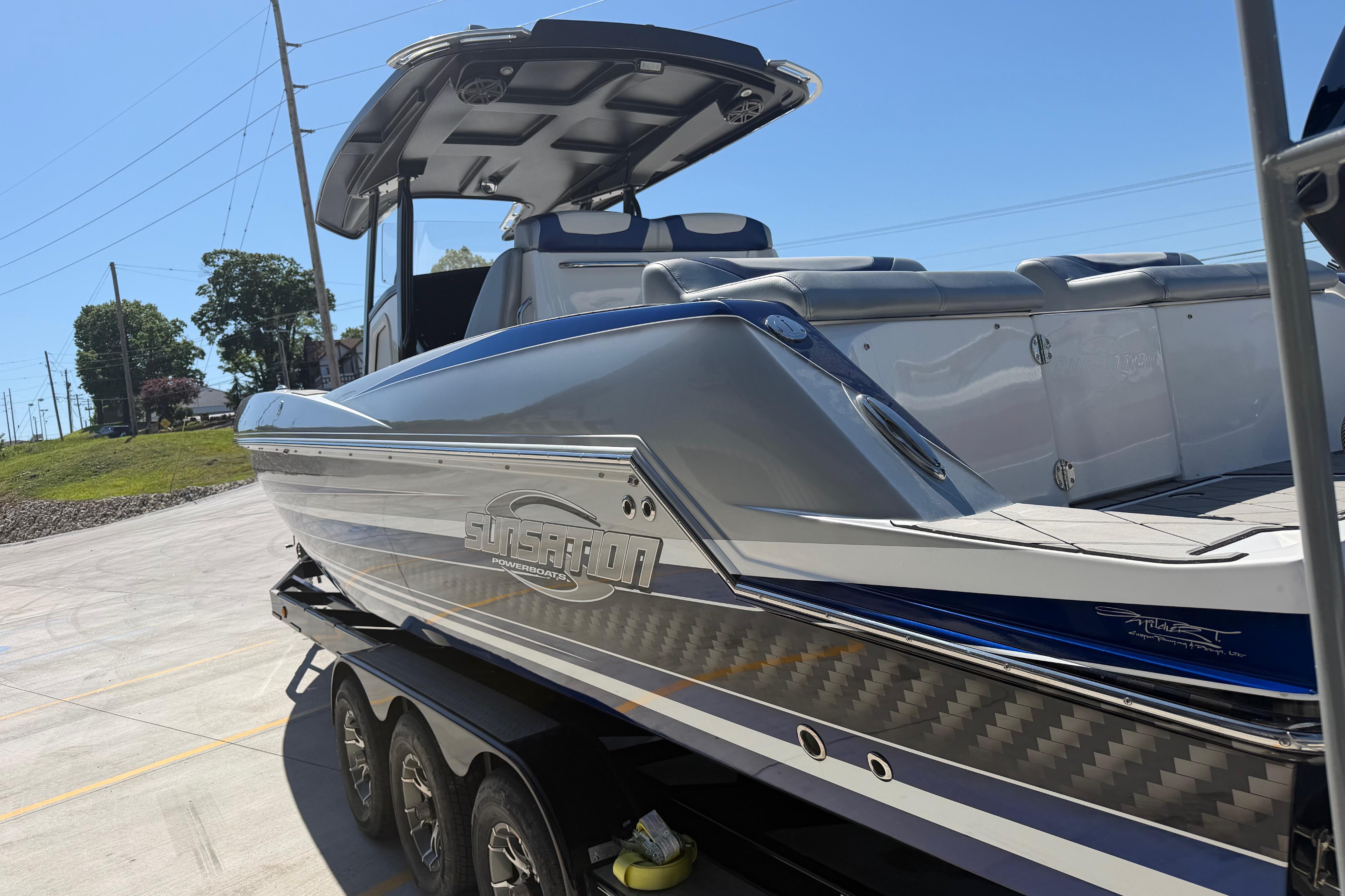 2018 Sunsation 32 CCX powerboat on trailer, showcasing sleek design and modern features.