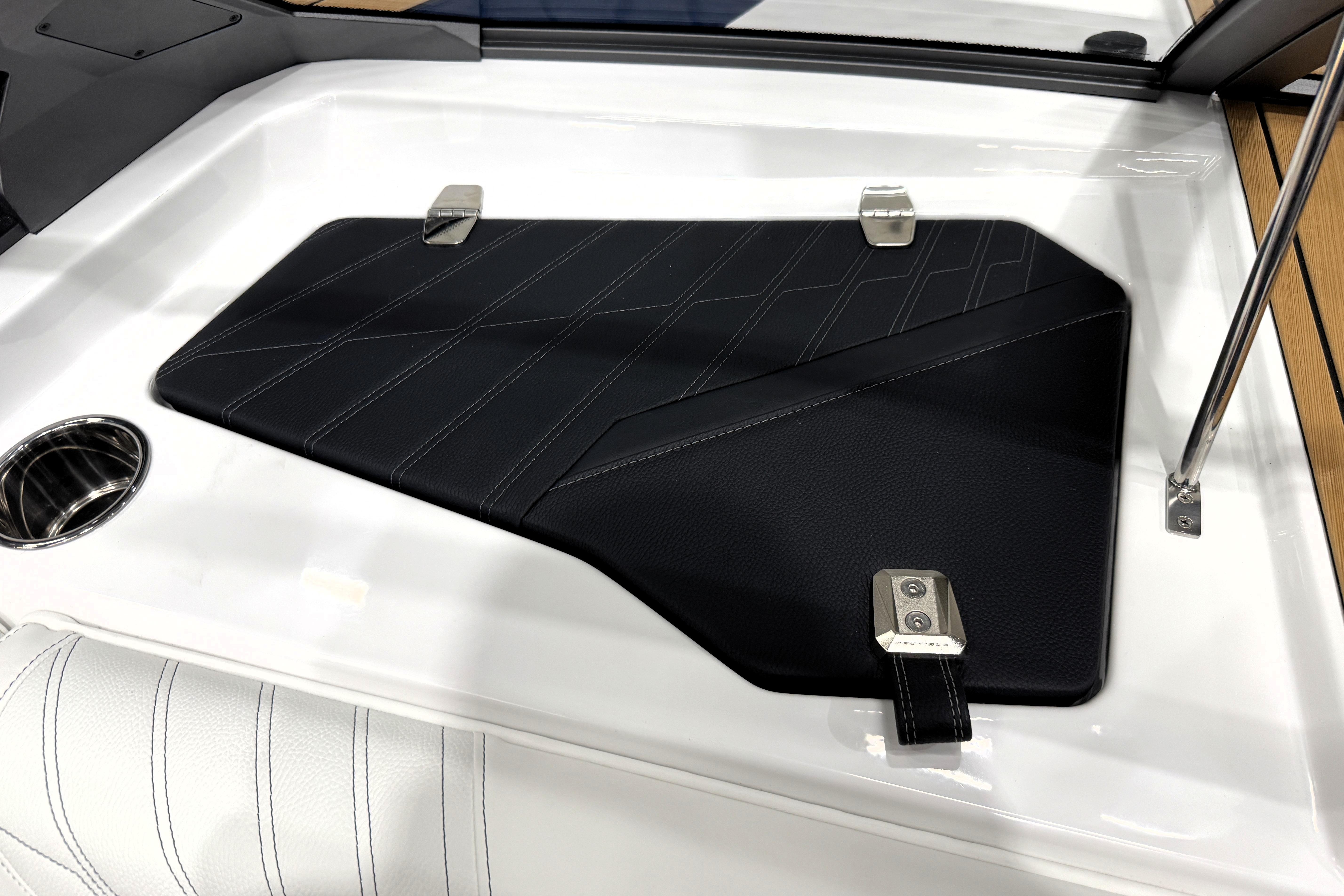 2026 Nautique Ski Nautique interior detail with sleek black panel and cup holder.