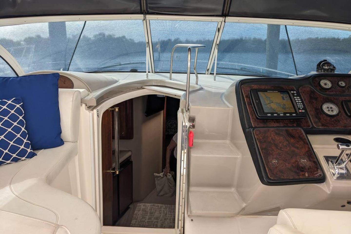 Interior view of 2003 Cruisers 3970 yacht cockpit with navigation system and seating.
