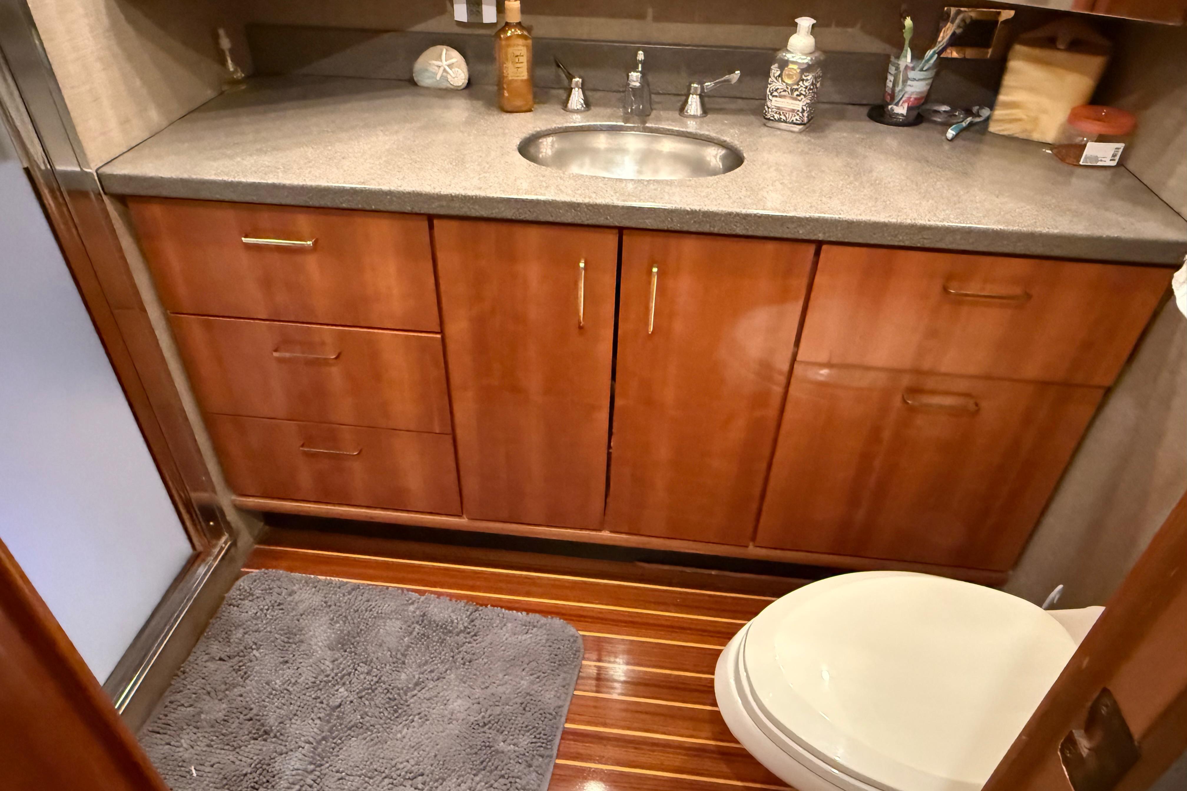 Luxurious bathroom in 2000 Northern Pacific Motor Yacht with wooden cabinetry and modern fixtures.