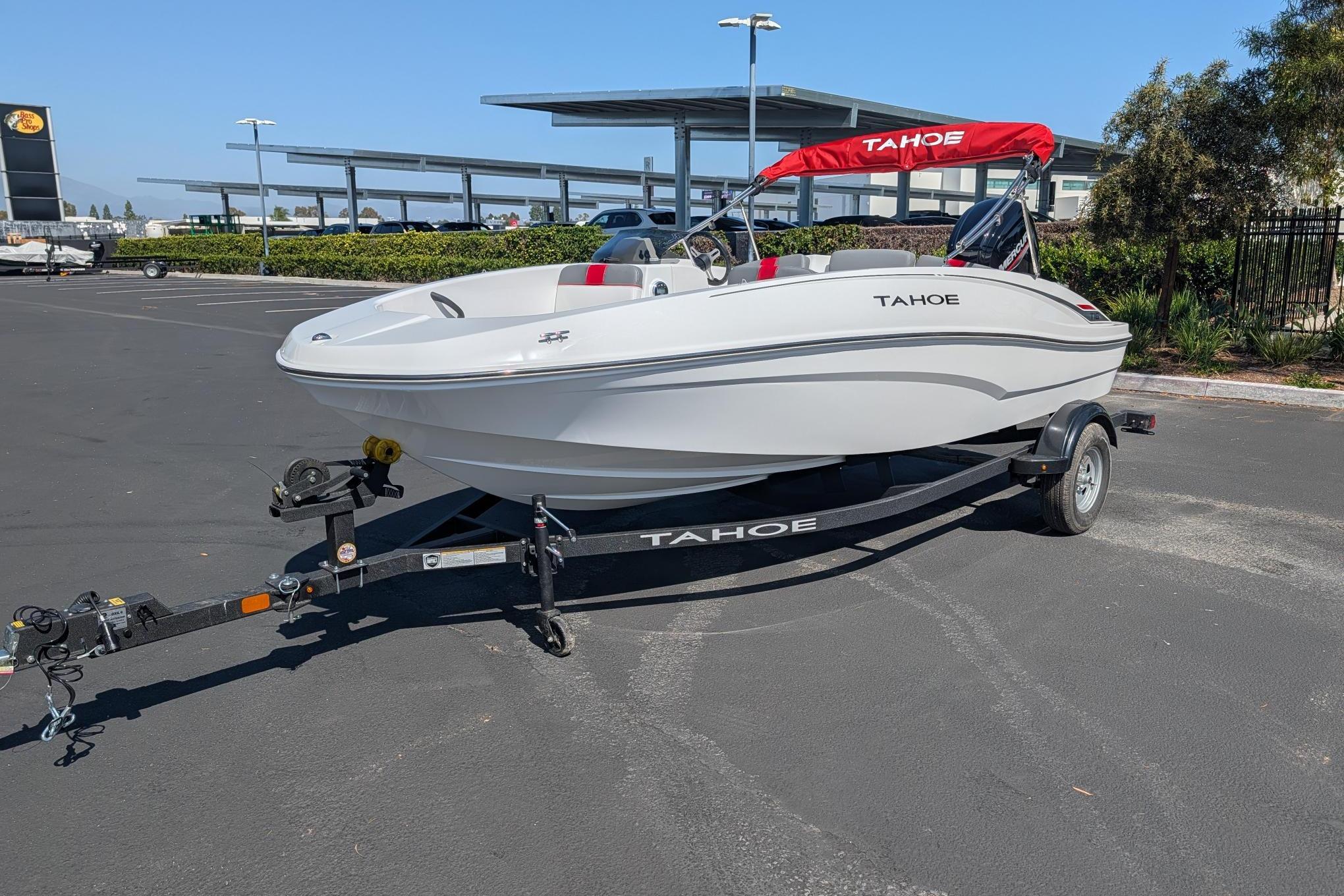 2026 Tahoe T16 boat on trailer in parking lot, featuring red canopy.