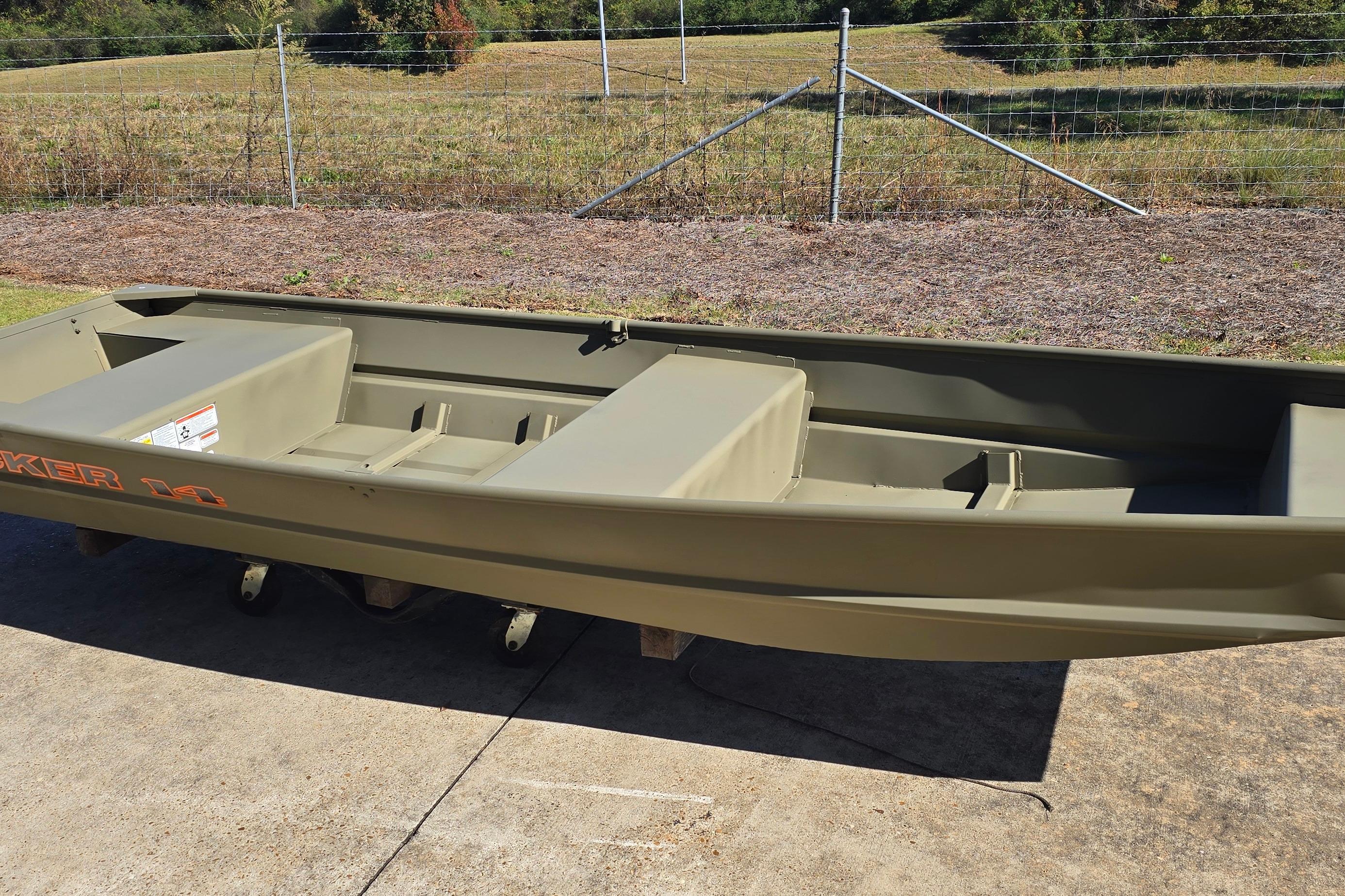 2026 Tracker Grizzly 14 Jon boat on concrete, with grassy background.