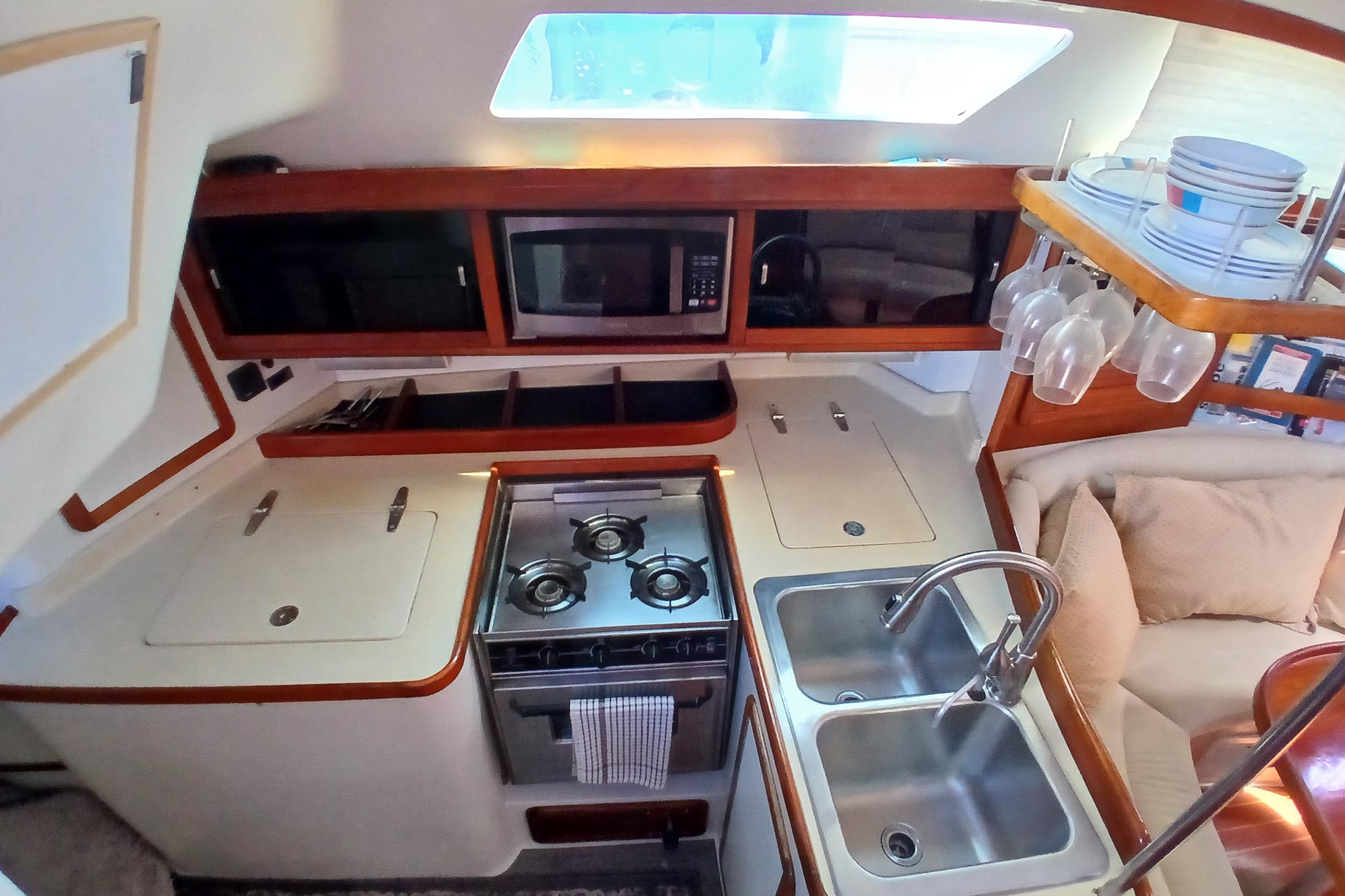 1995 Catalina 42 MkII yacht kitchen with stove, double sink, and microwave.