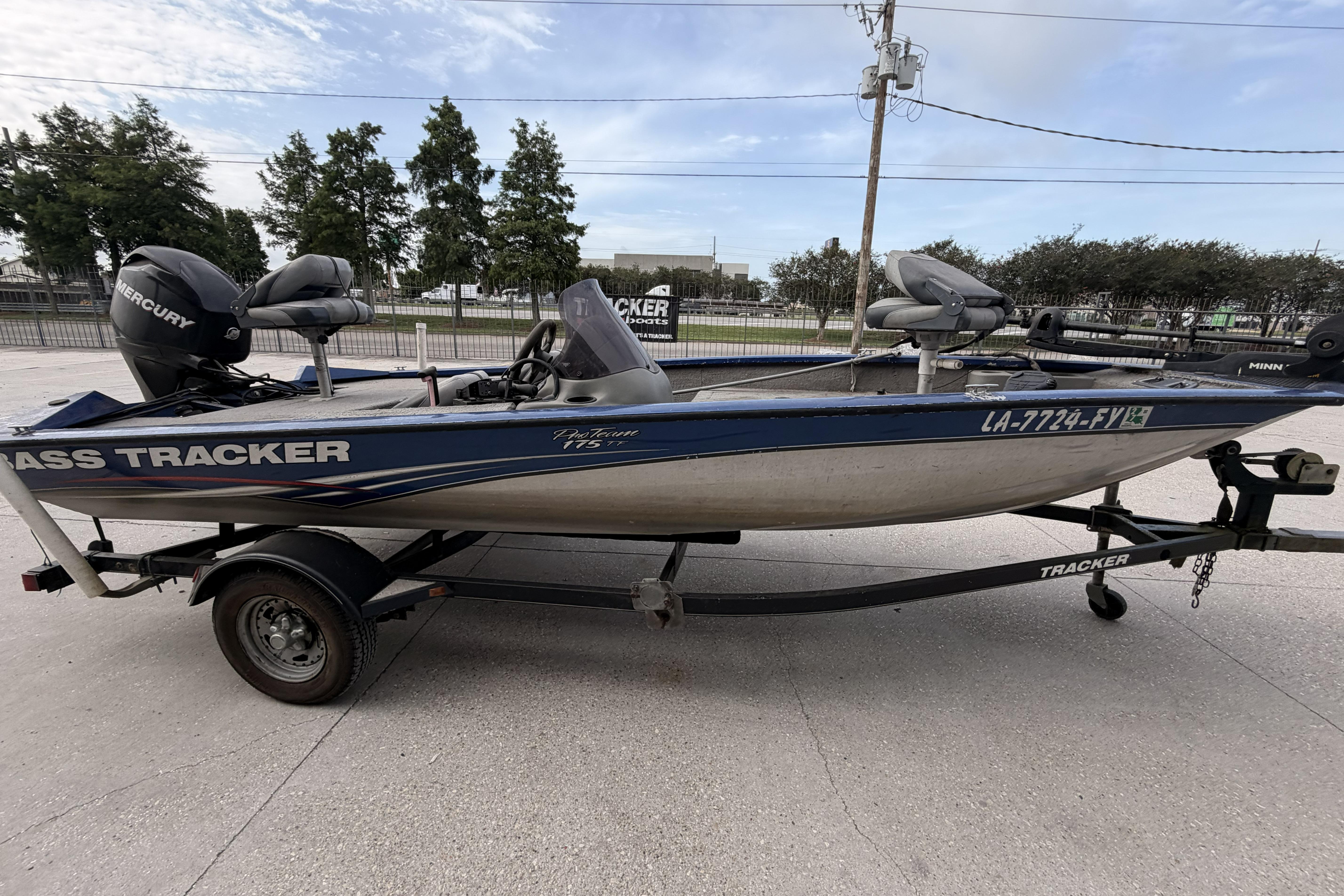 2012 Bass Tracker Pro 17 fishing boat on trailer, parked outdoors.