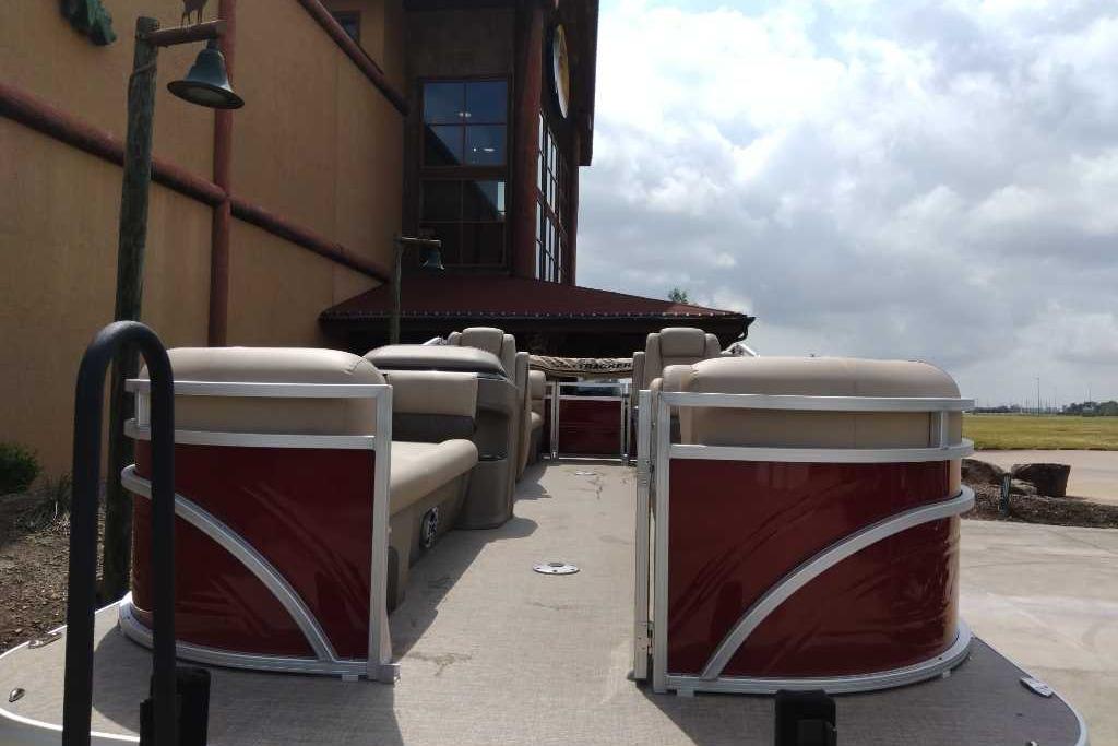 2025 Sun Tracker Party Barge 22 DLX pontoon boat parked outdoors.