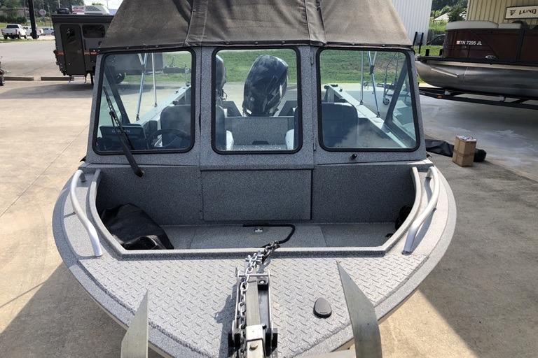 2023 Alumaweld Talon 18 boat with covered cabin, parked outdoors.