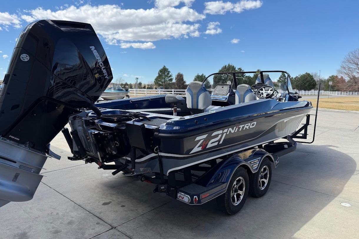 2026 Nitro ZV21 Pro boat with Mercury engine on a trailer, parked outdoors.