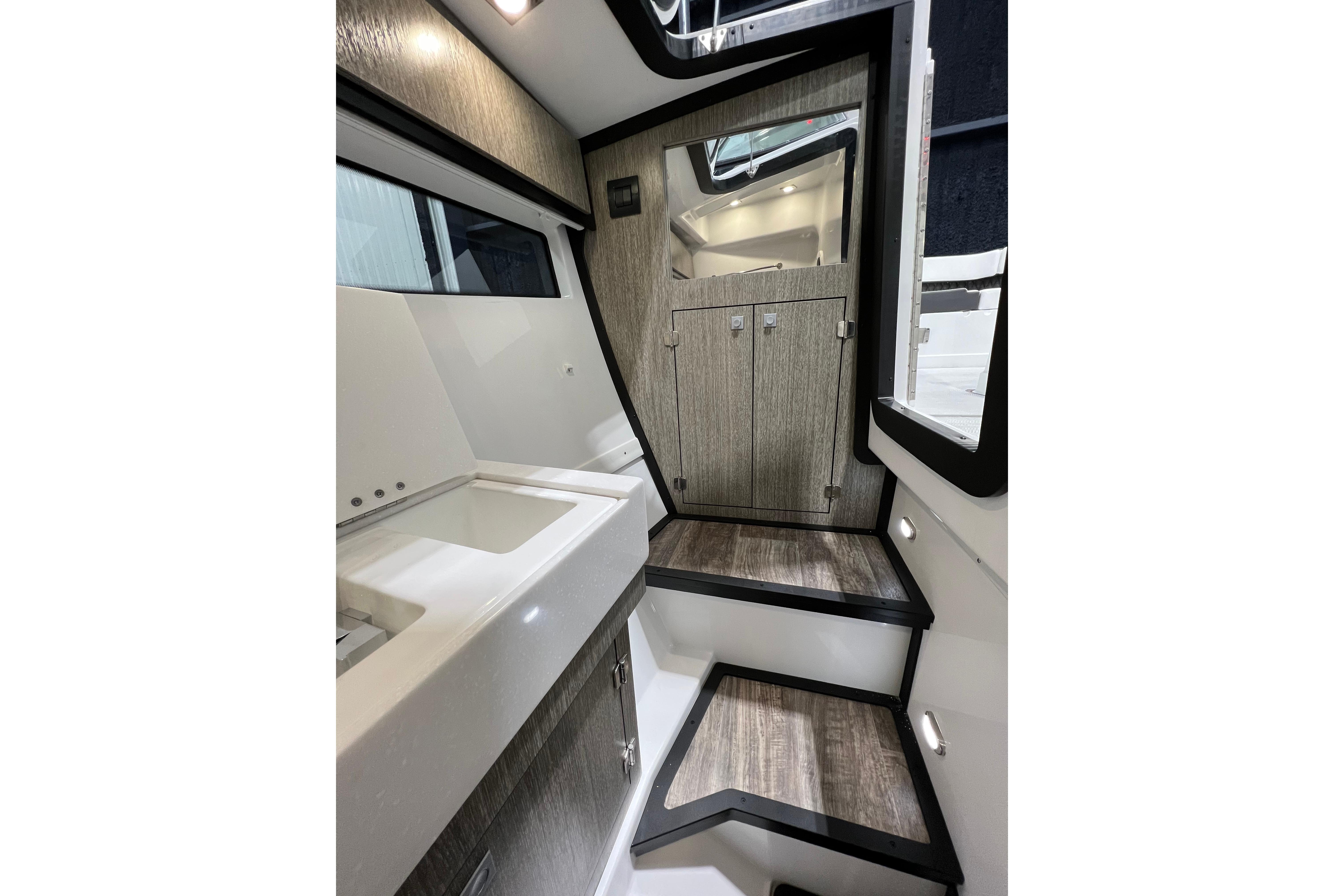 Interior of 2023 Monterey 378SS Super Sport boat, featuring sleek cabinetry and modern design.