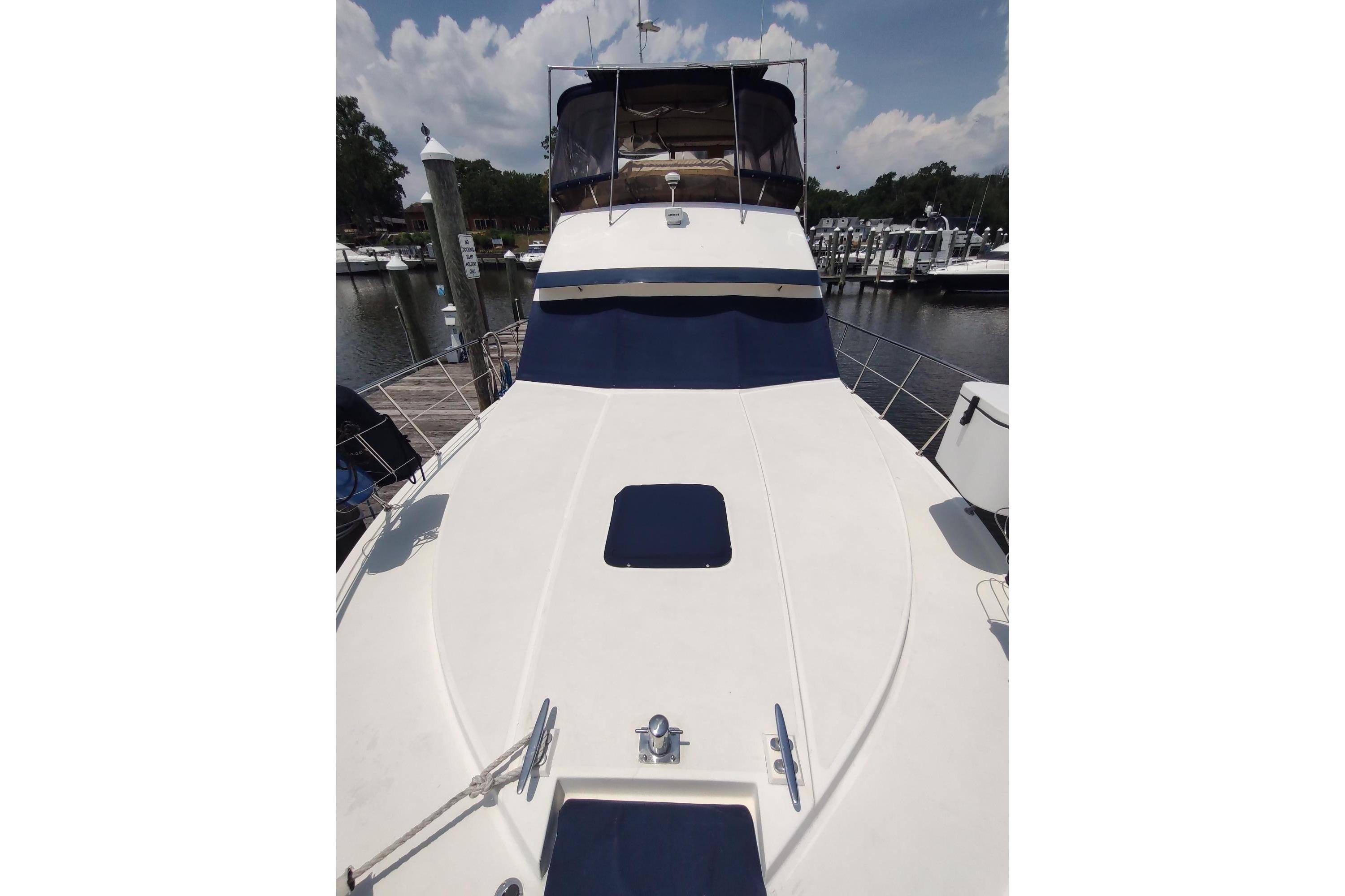 1989 Hyatt Double Cabin Motoryacht docked at marina, showcasing sleek deck design.