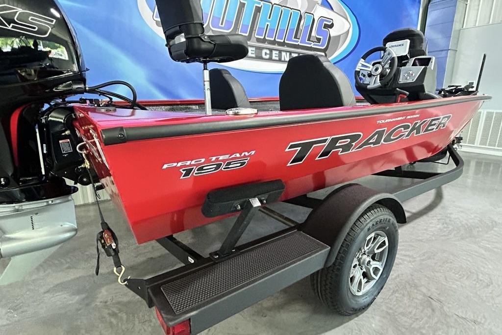 2026 Tracker Pro Team 195 boat in showroom, red exterior, on trailer.