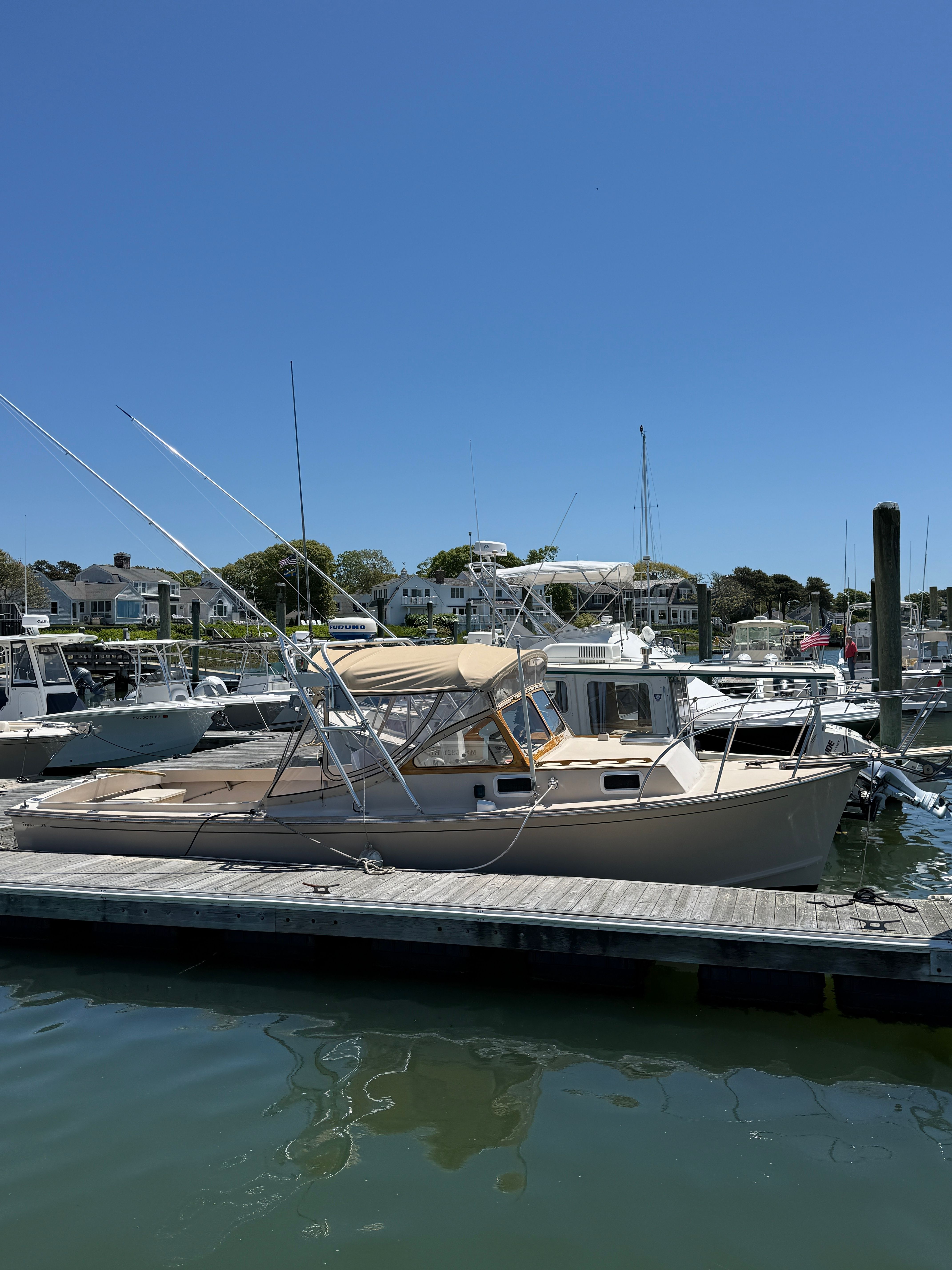 A 1989 Fortier 26 boat docked on a sunny day.