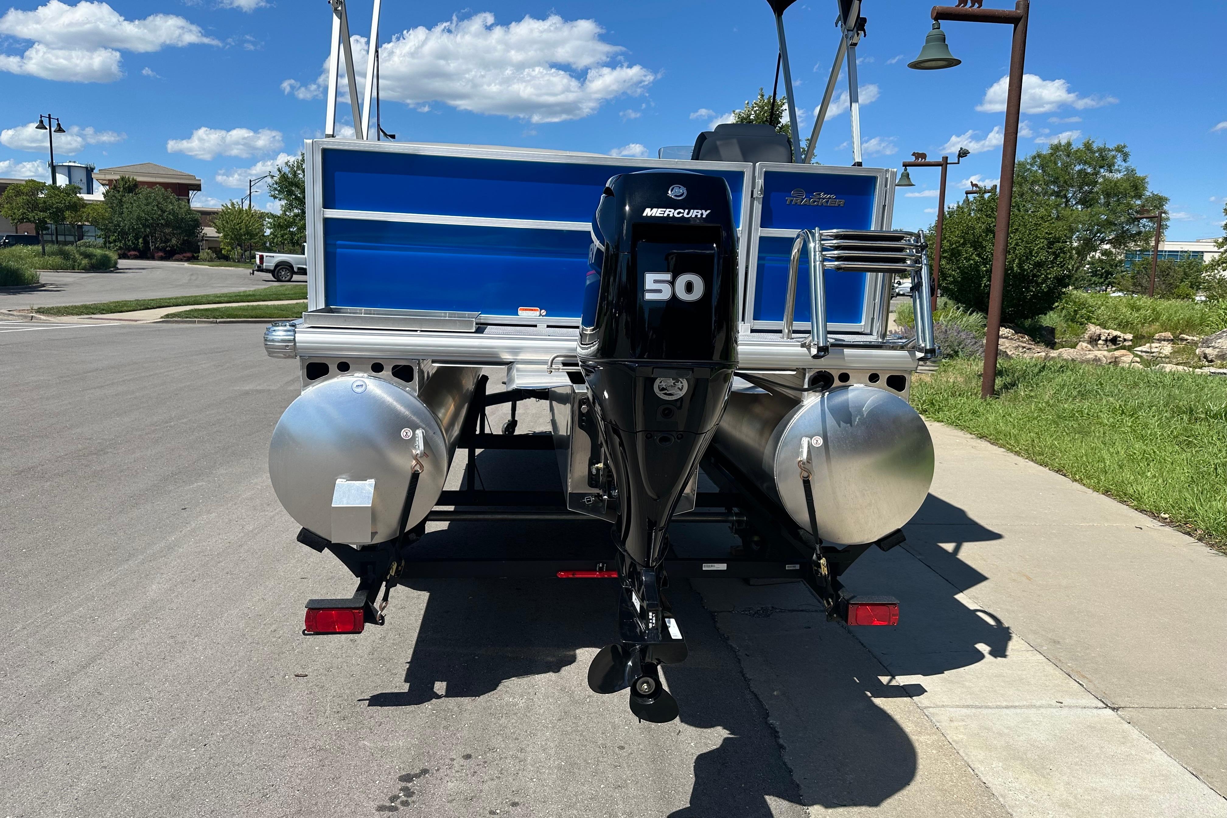 2026 Sun Tracker Party Barge 16 DLX with Mercury 50 engine, parked on a sunny day.