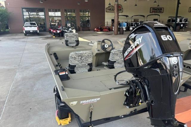 2026 Tracker Grizzly 1754 SC boat with Mercury 60 engine in showroom.