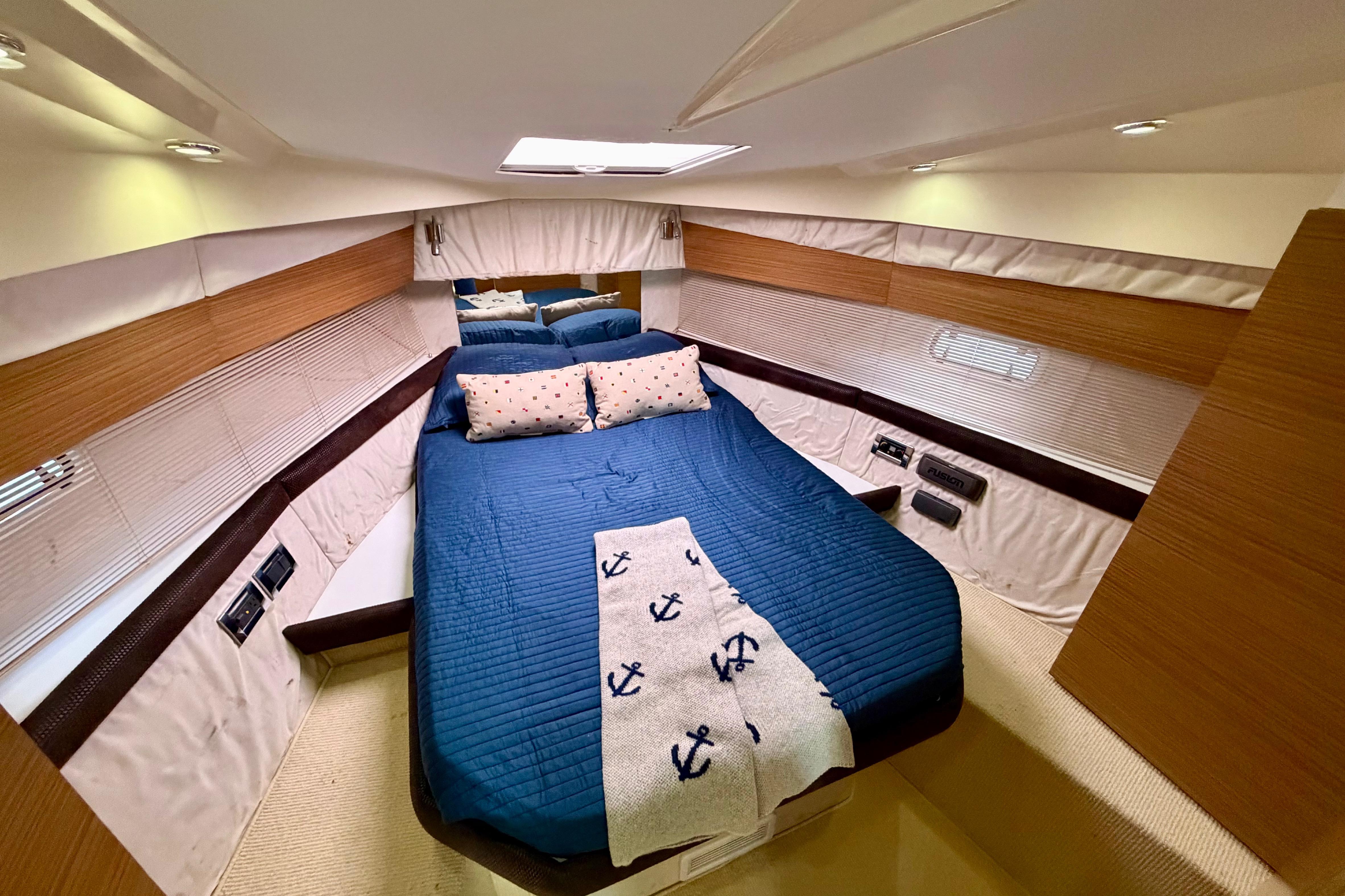Luxurious cabin interior of 2014 Azimut Verve 40 yacht with cozy bedding.
