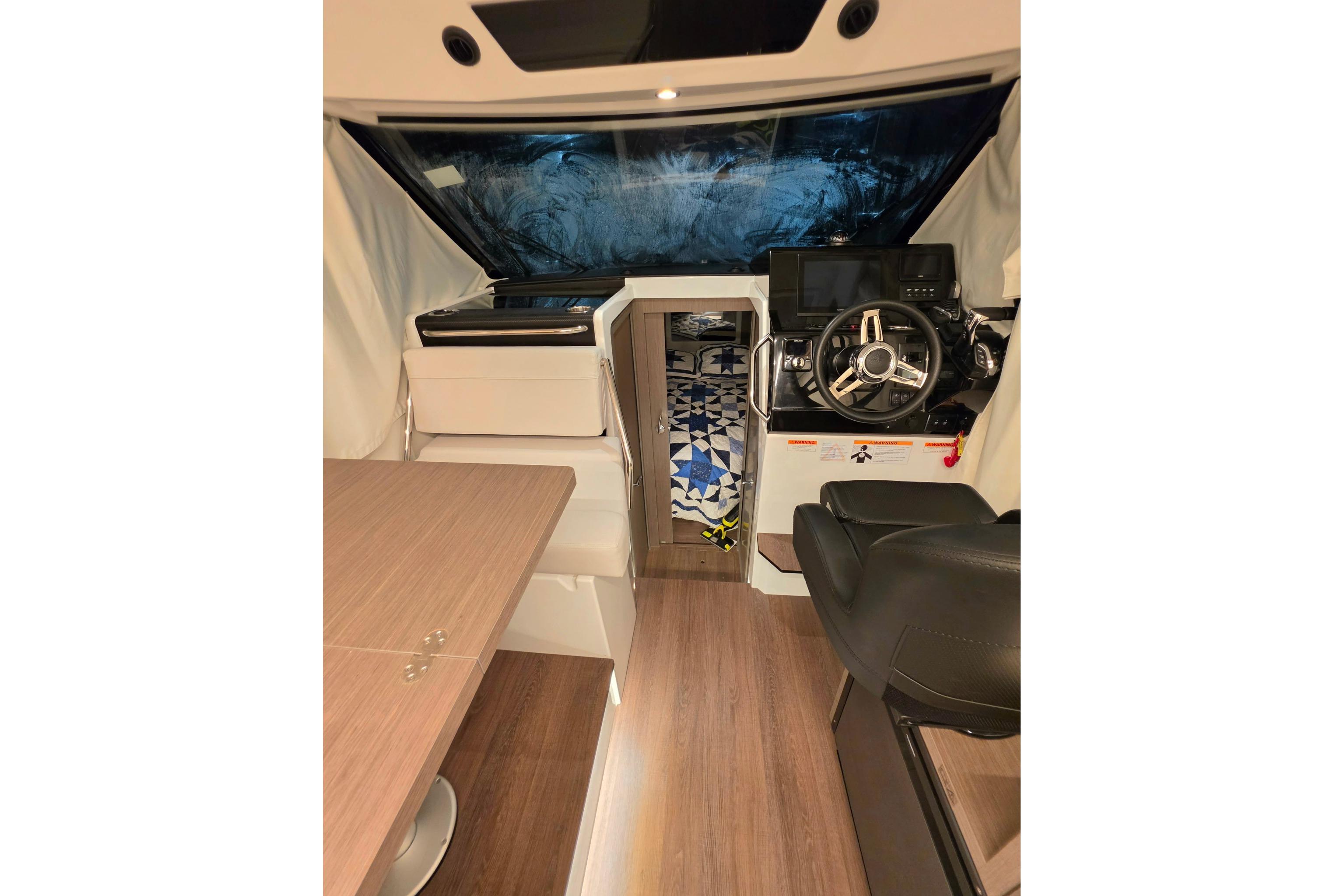 Interior of 2026 Jeanneau NC 895 Series 2 boat, featuring helm and seating area.
