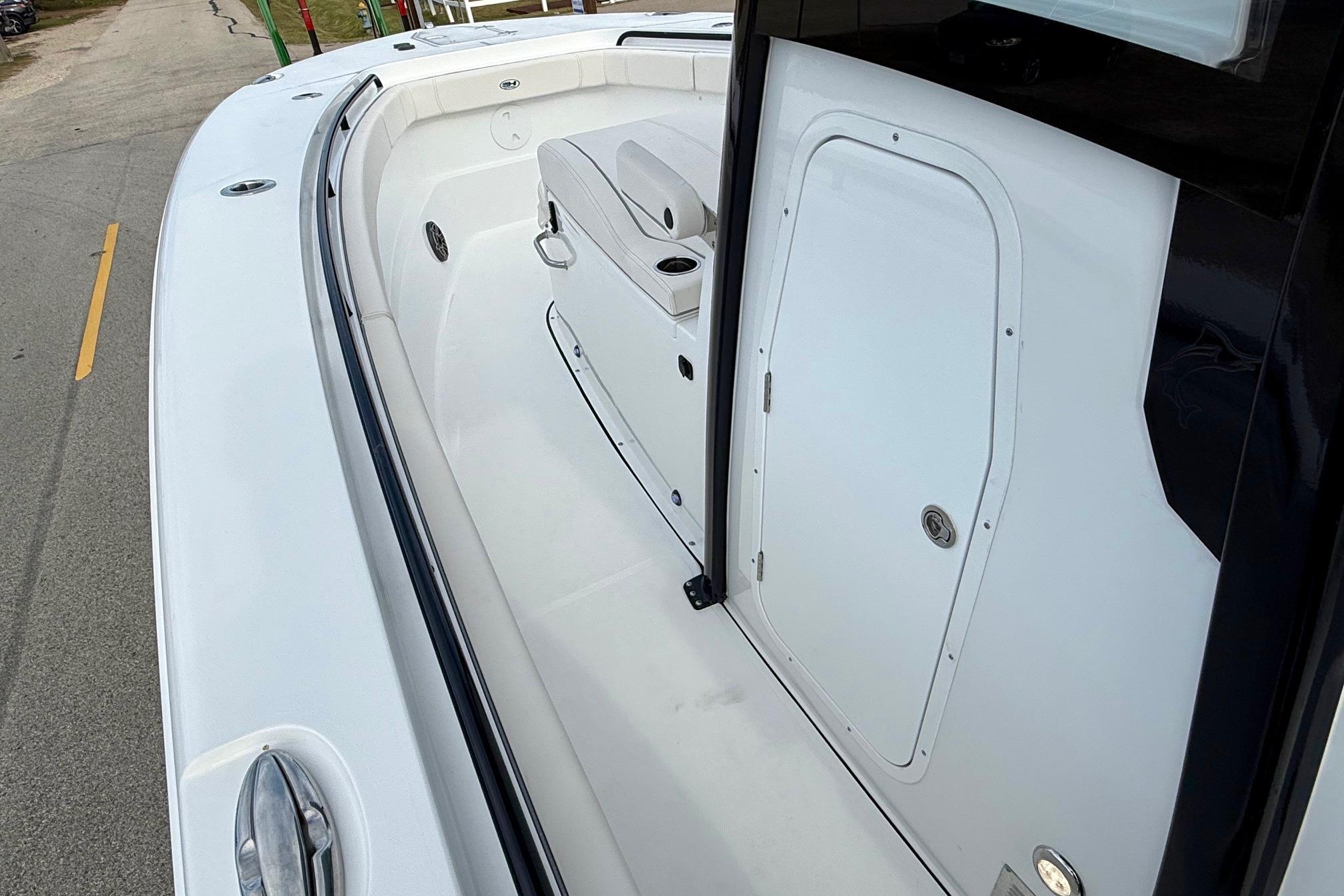2026 Sea Hunt Gamefish 30 Coffin Box boat interior, featuring sleek white design and storage compartment.