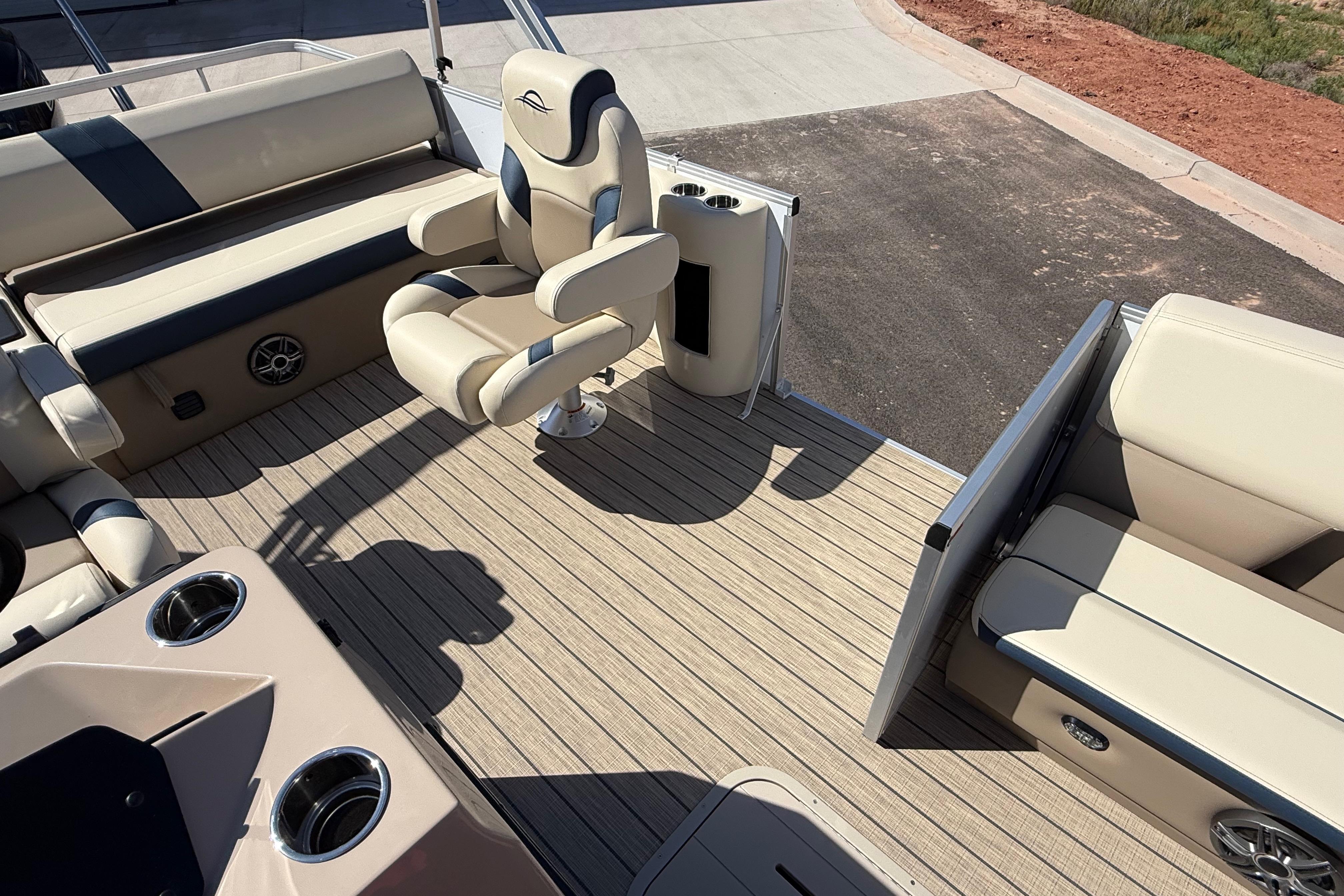Luxurious interior of 2026 SunCatcher Select 322SL pontoon boat with plush seating and cup holders.