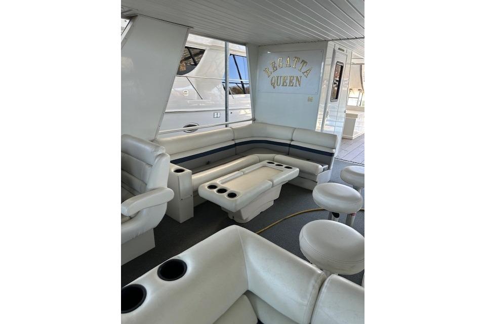 Luxurious interior of 2008 Destination Yachts 45X14, featuring plush seating and "Regatta Queen" sign.