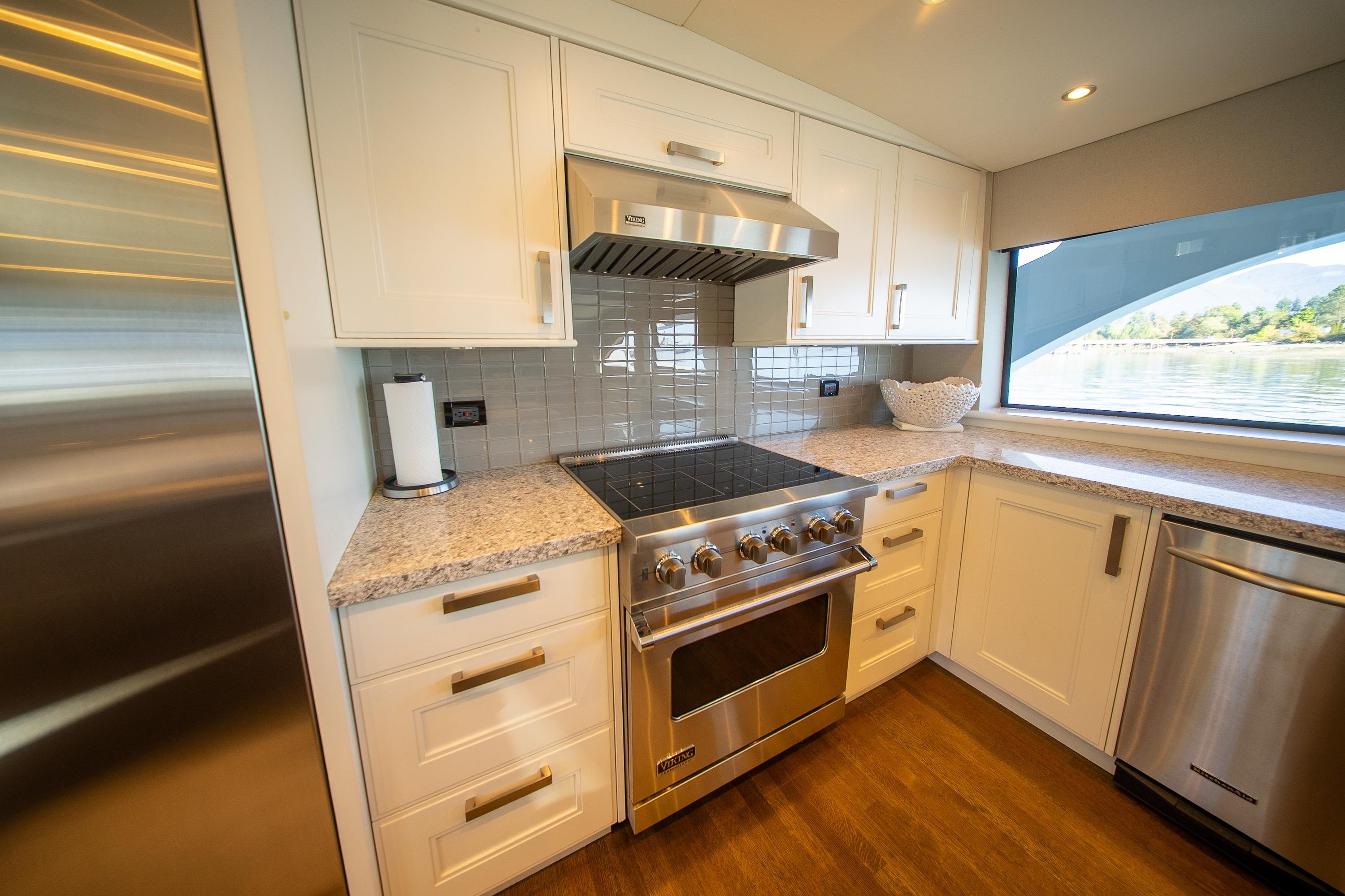 Modern kitchen in 1992 Crescent Custom yacht with stainless steel appliances and granite countertops.