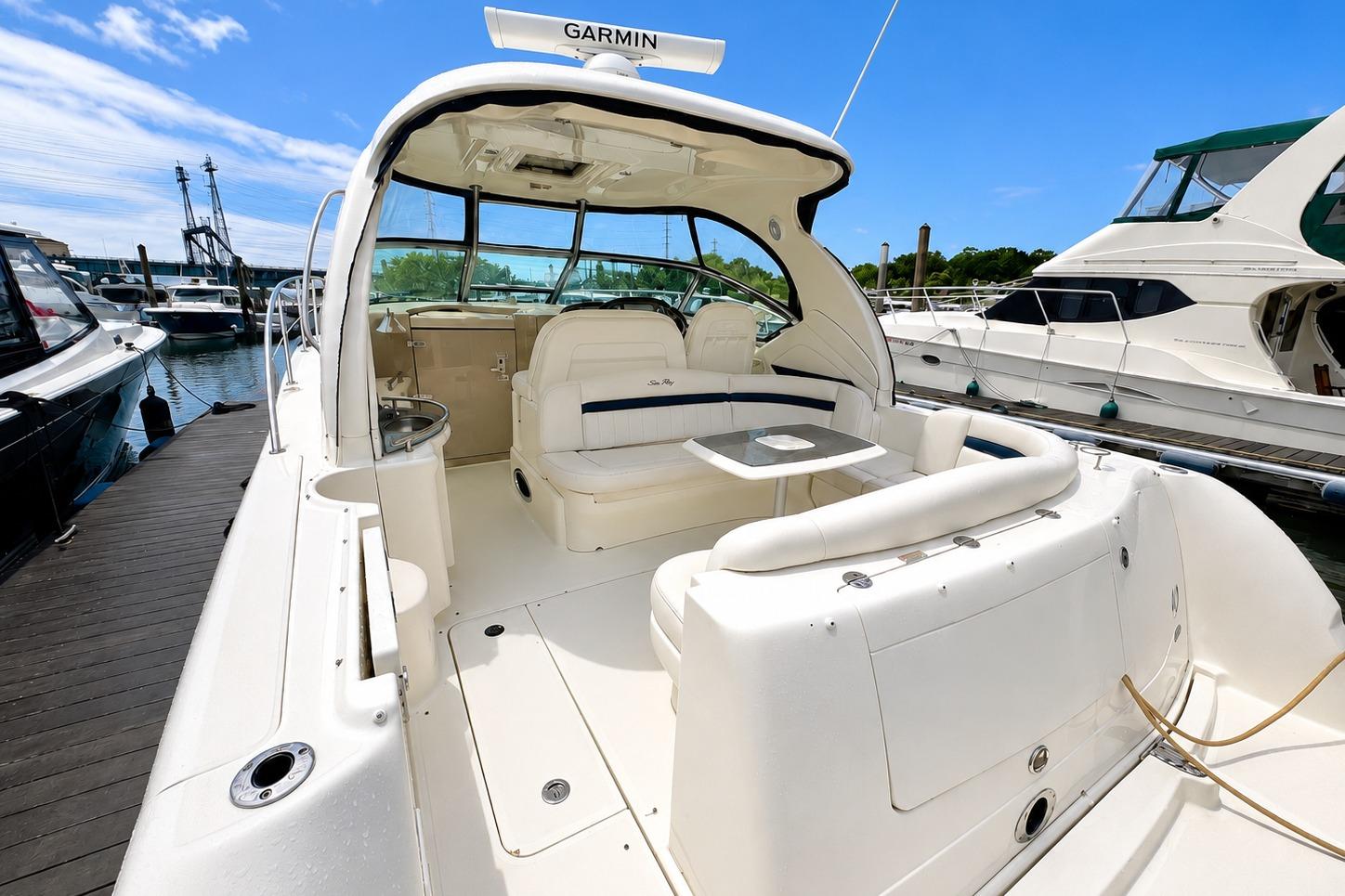 2006 Sea Ray 40 Sundancer yacht docked, featuring spacious seating and modern design.