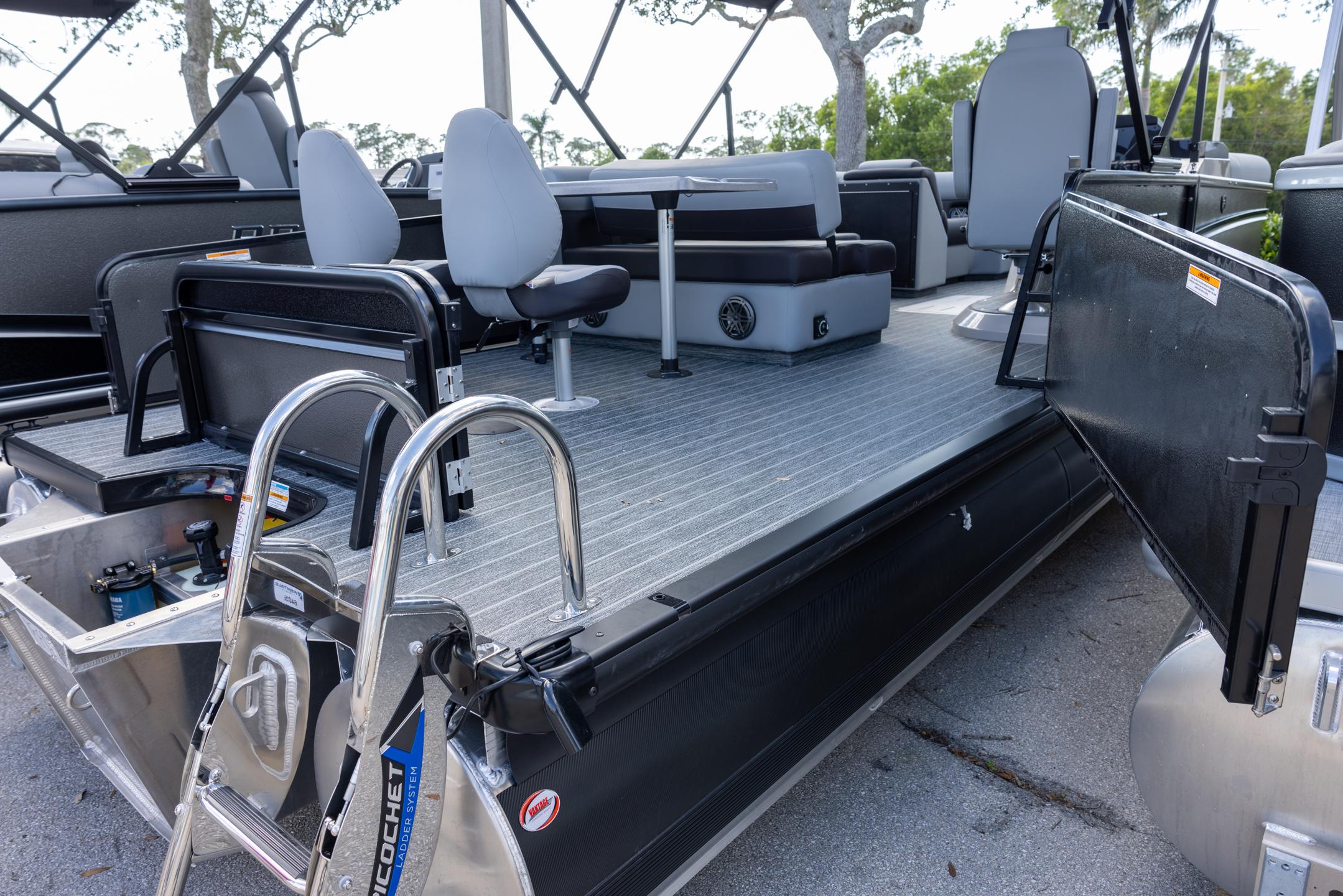 2025 Premier 230 Sunsation RS pontoon boat with seating and ladder, docked outdoors.