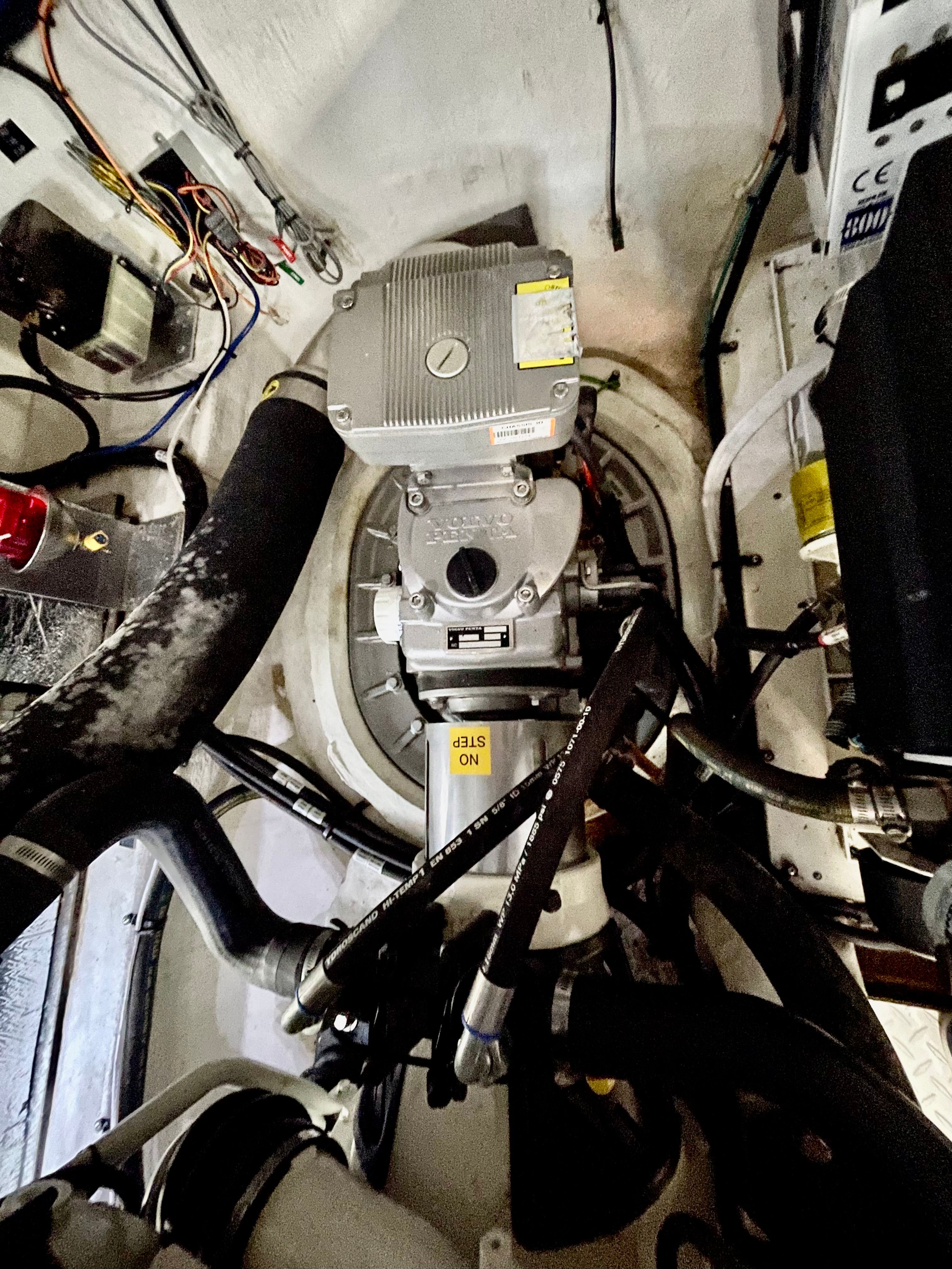 Engine room of a 2016 Cruisers Yachts 390 Express Coupe with visible hoses and cables.