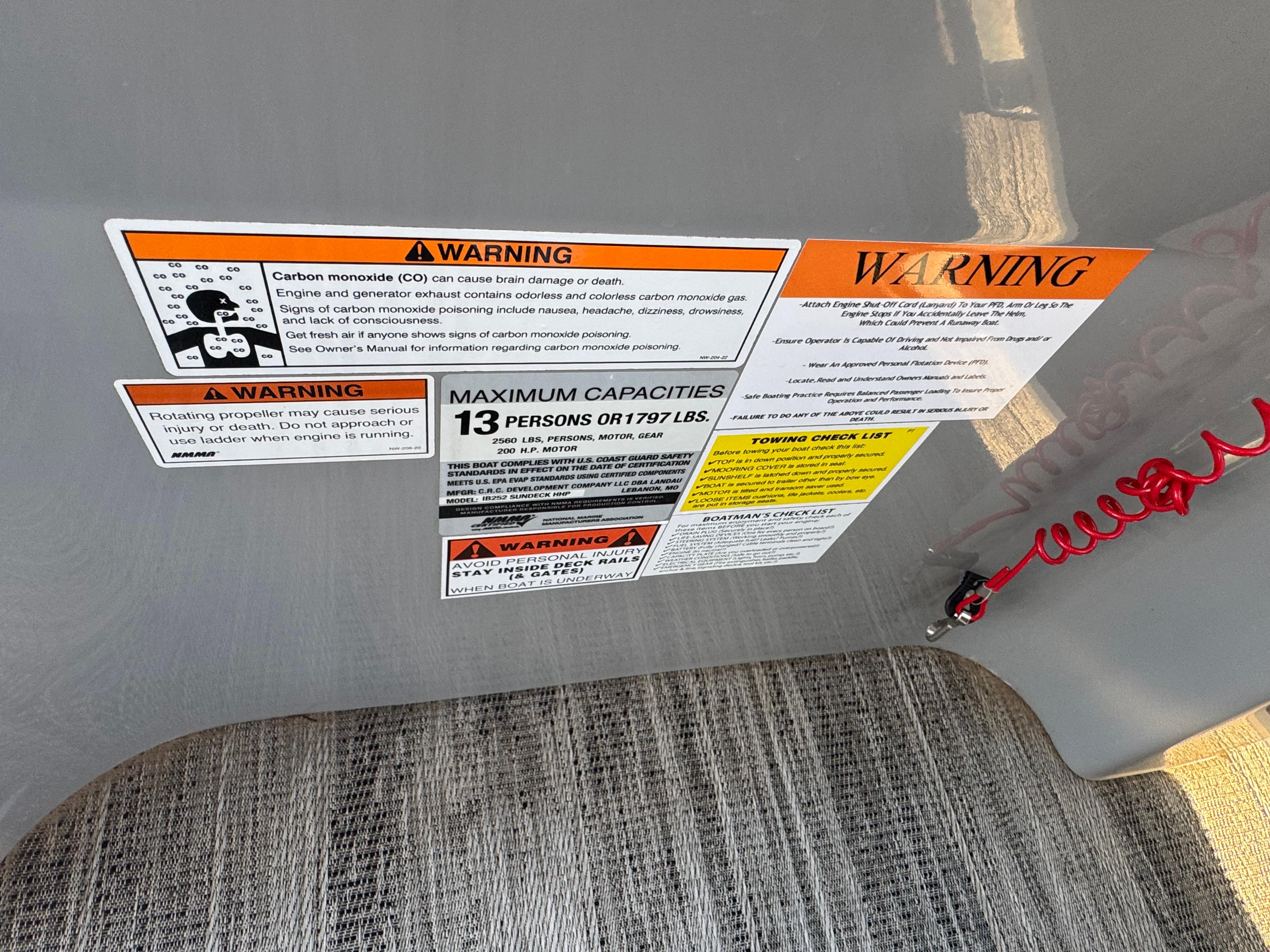 Warning labels on 2024 Landau Island Breeze 252, detailing safety and capacity information.