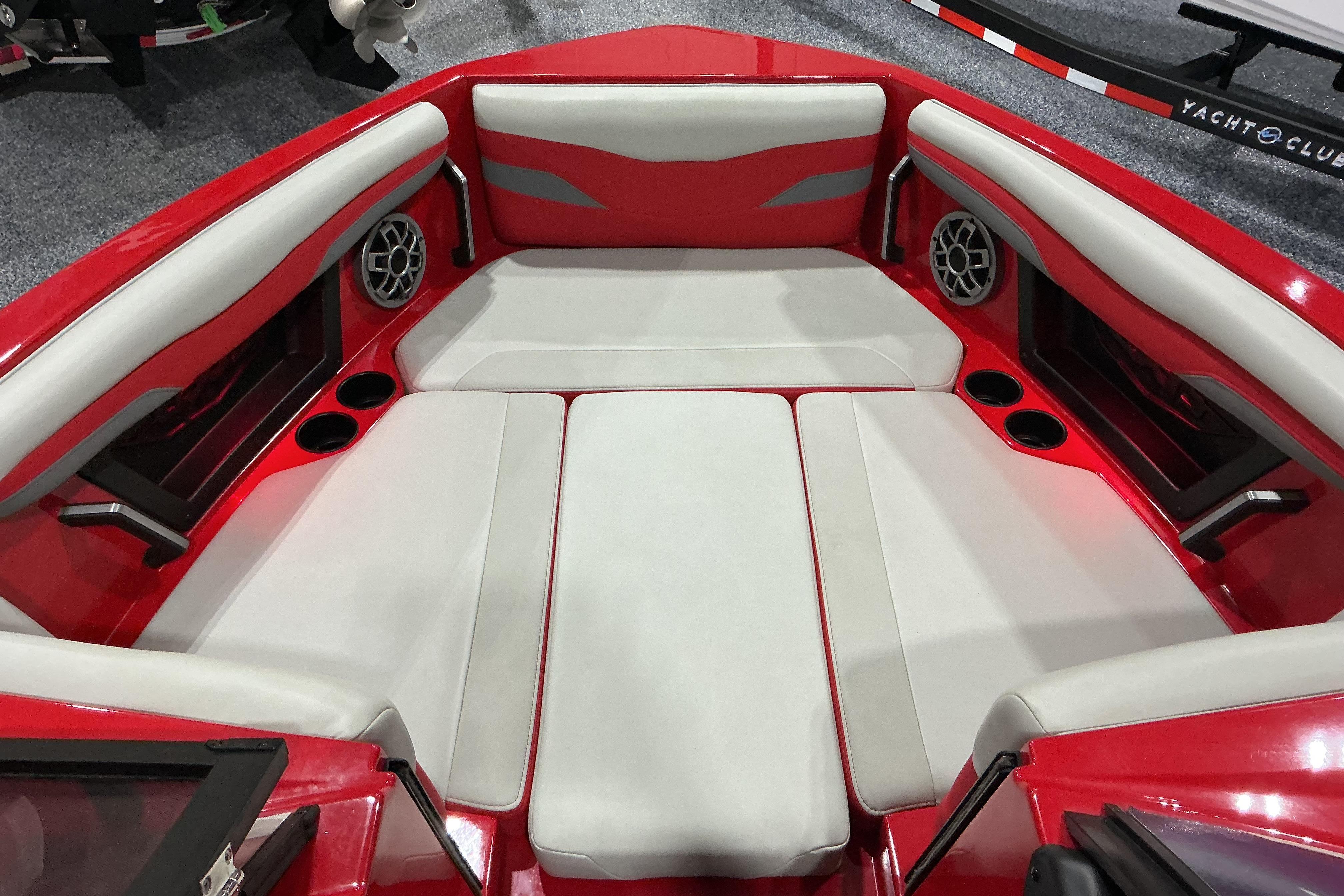 Red and white interior of 2022 Axis T250 boat with seating and speakers.