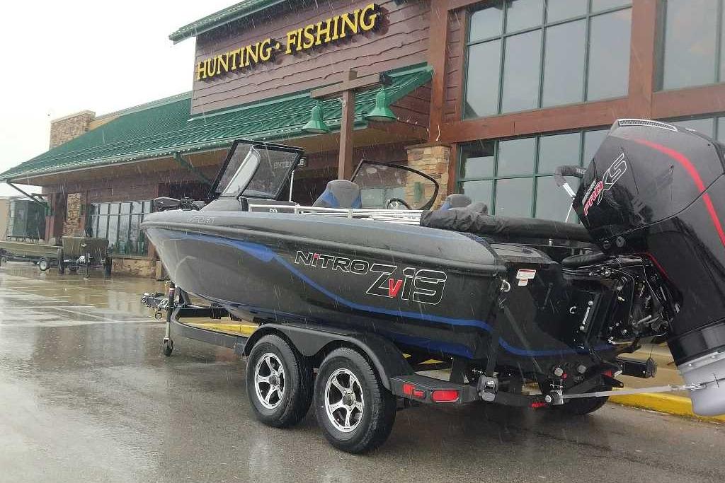 2026 Nitro ZV19 Sport Pro boat parked outside hunting and fishing store.