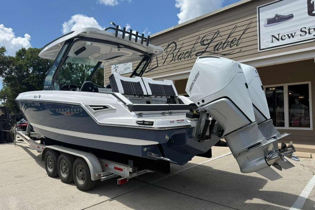 2026 Monterey Elite 30 OB boat on trailer, featuring dual Mercury outboard engines.