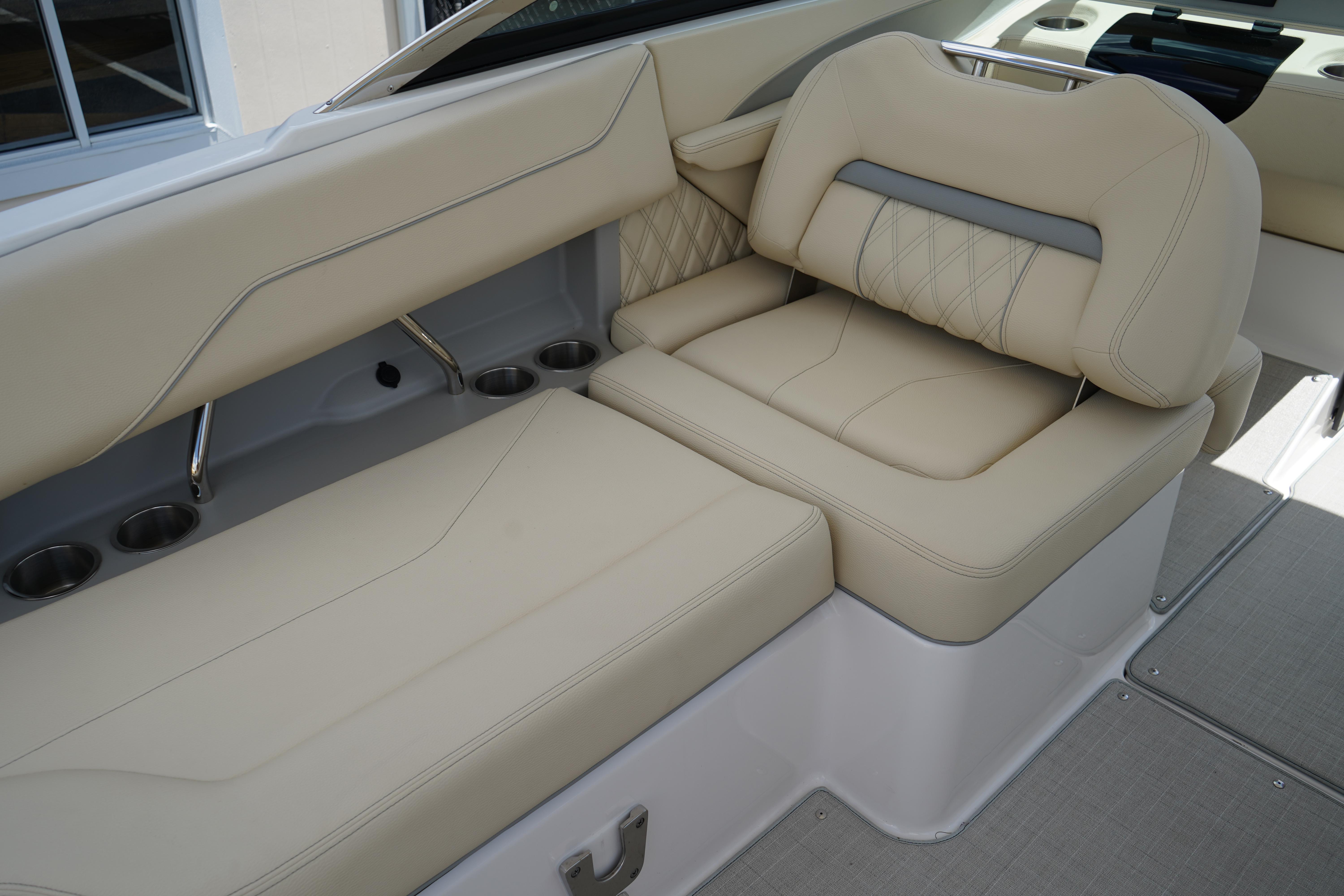2023 Regal LX4 boat interior with beige leather seating and cup holders.
