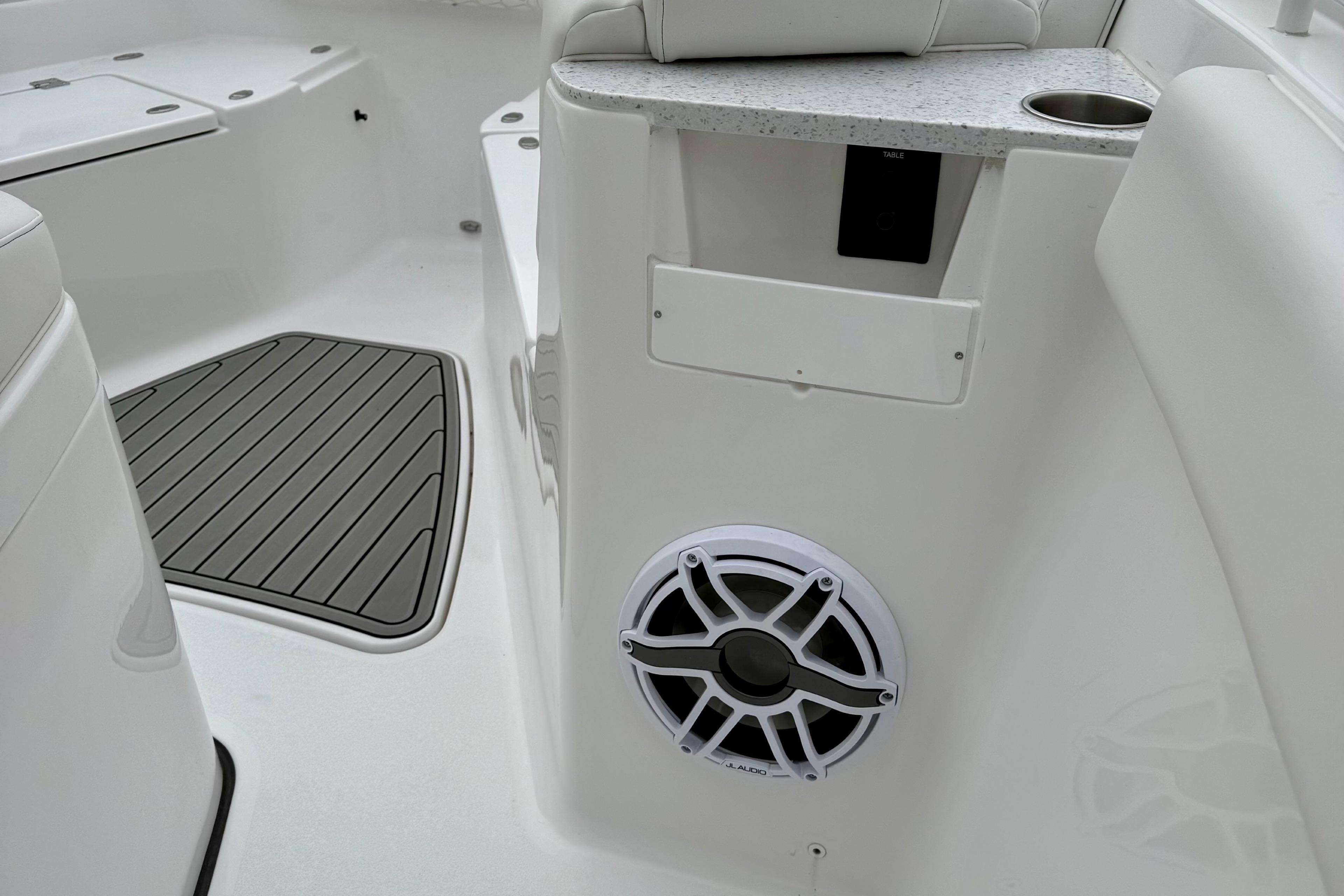 2026 Tidewater 302 CC Adventure boat interior with speaker and seating area.