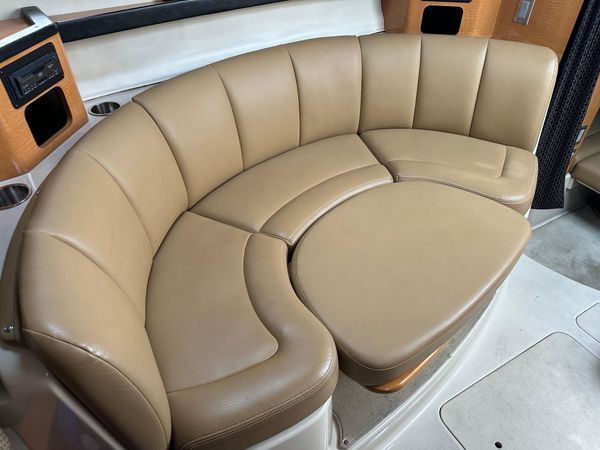 Interior of 2006 Chaparral Signature 310 boat with beige leather sofa.