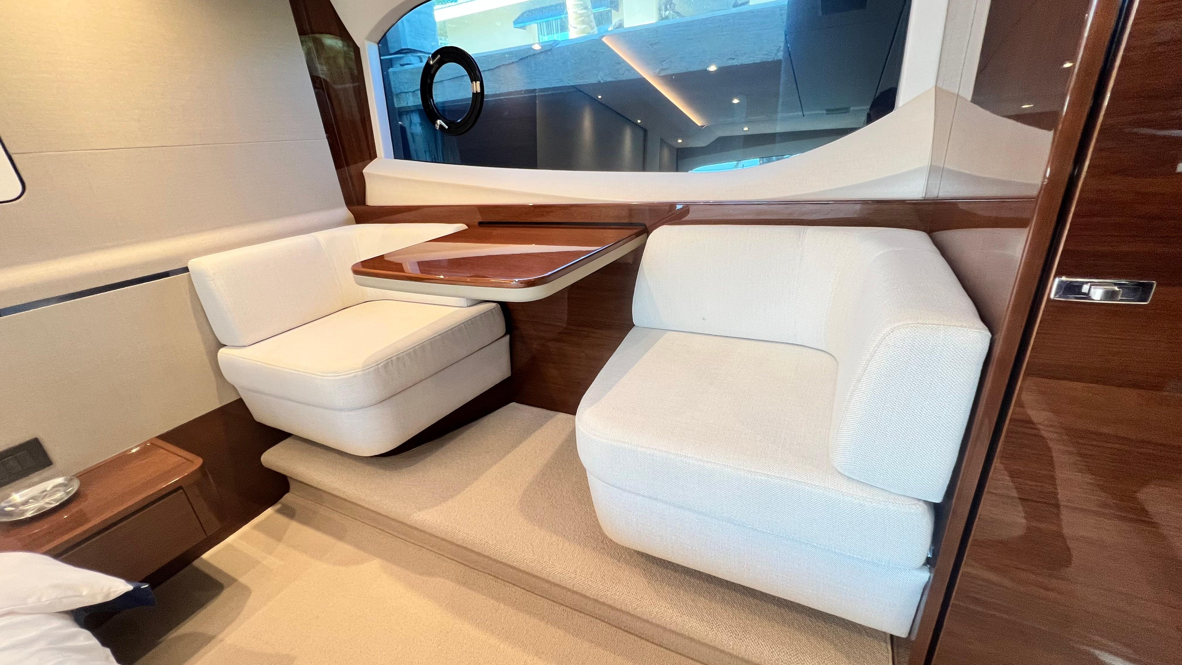 Luxurious interior of 2019 Princess F62 yacht with elegant seating and wooden accents.
