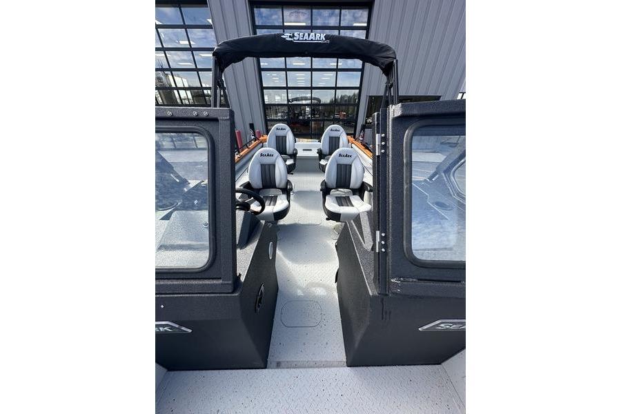 2026 SeaArk ProCat 240 boat interior with seating and canopy, displayed in a showroom.