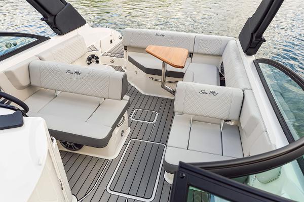 Manufacturer Provided Image: 2025 Sea Ray SDX 250 boat interior with luxurious seating and wooden table.
