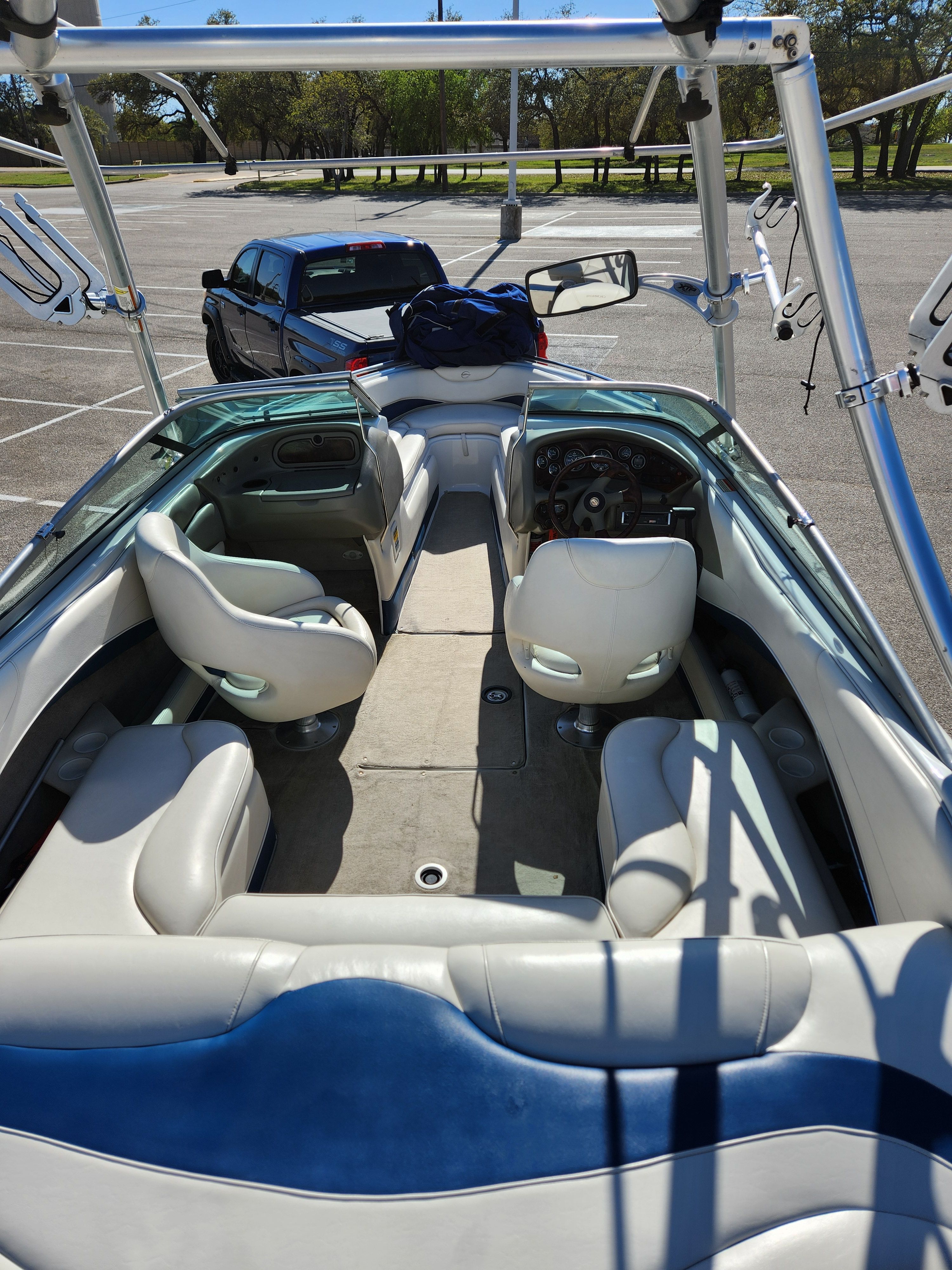 Interior view of a 2003 Crownline 225 BR boat in a parking lot.