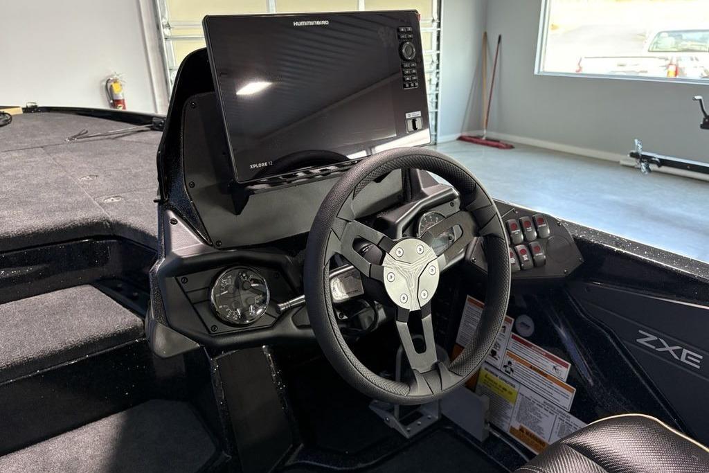 2026 Skeeter ZXE21 boat cockpit with steering wheel and advanced navigation display.