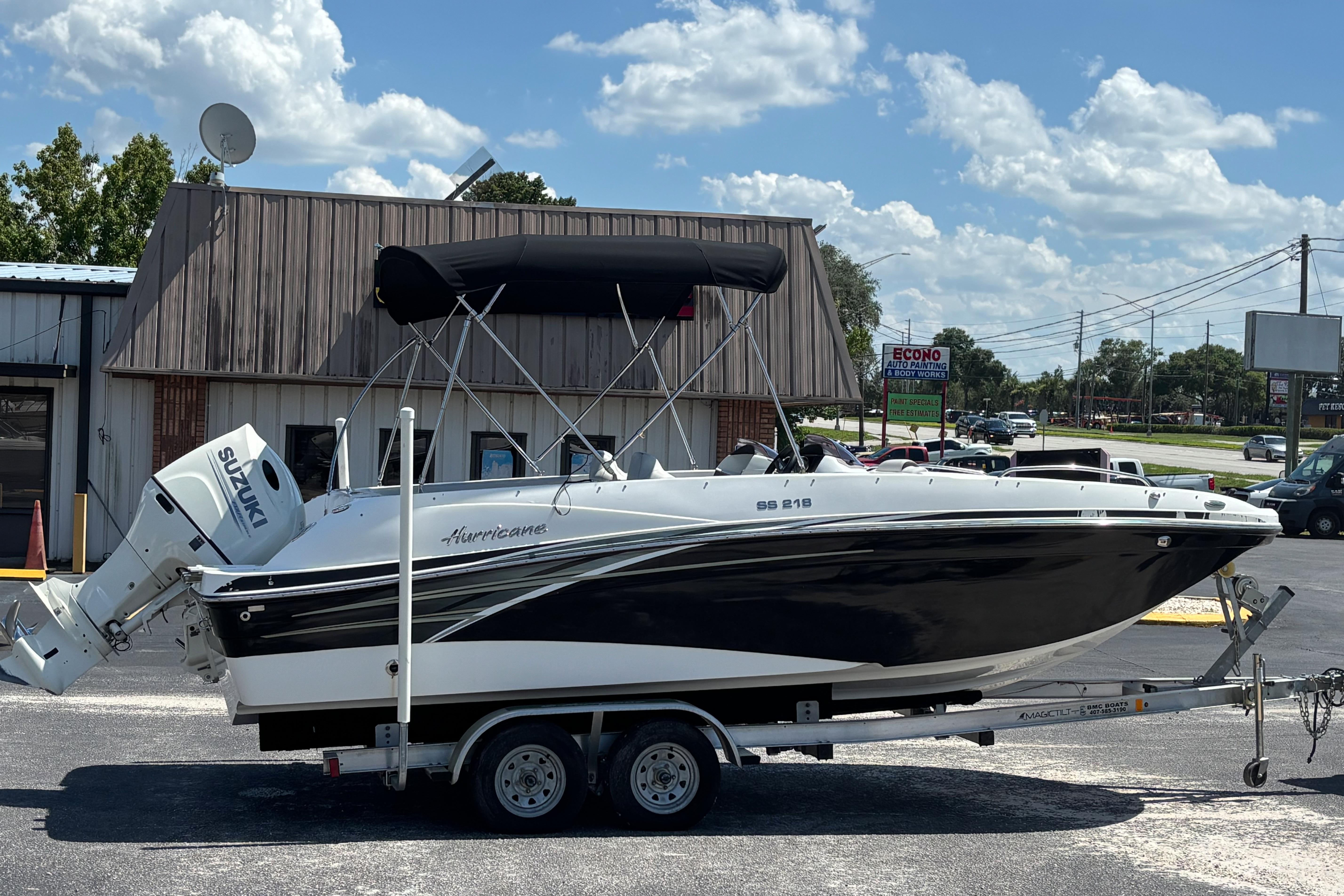 2019 Hurricane Sundeck Sport 218 OB boat on trailer, parked outdoors.